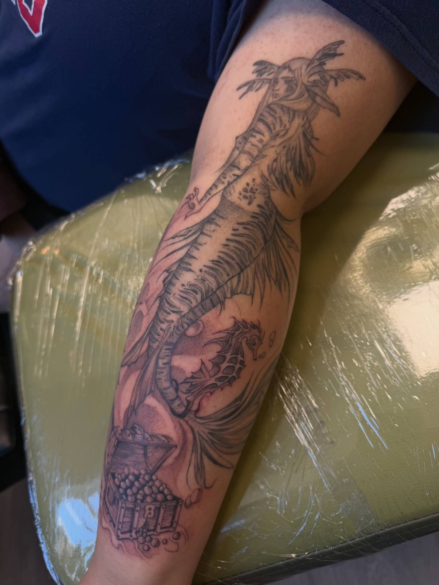 Pirate ship and treasure chest black and grey tattoo on the forearm by ashlyn rene