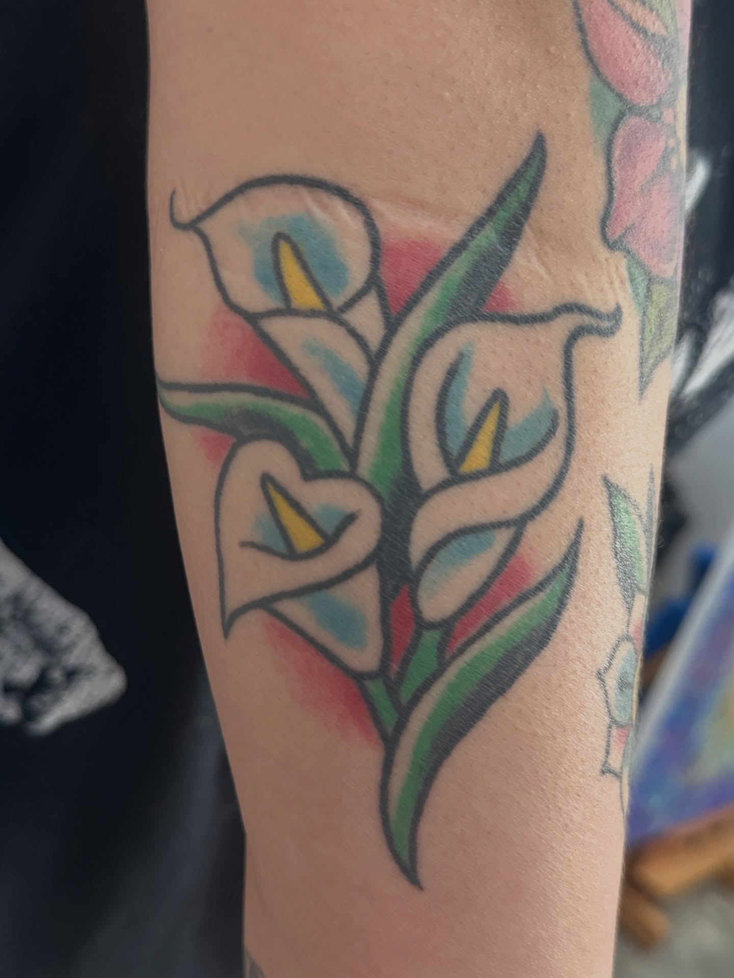 Calla lilies American traditional tattoo on the forearm by julian solis, Houston, Texas