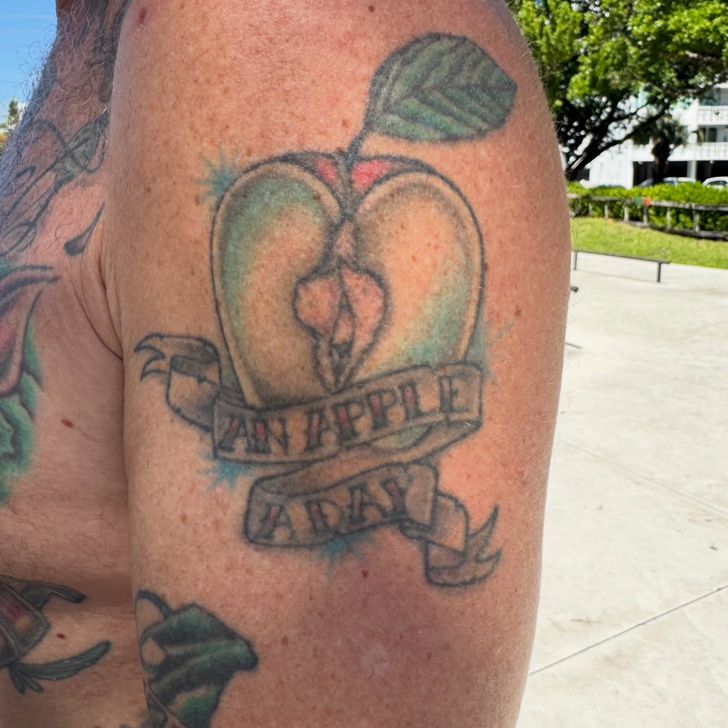 Apple American traditional tattoo on the forearm by Joint Killer