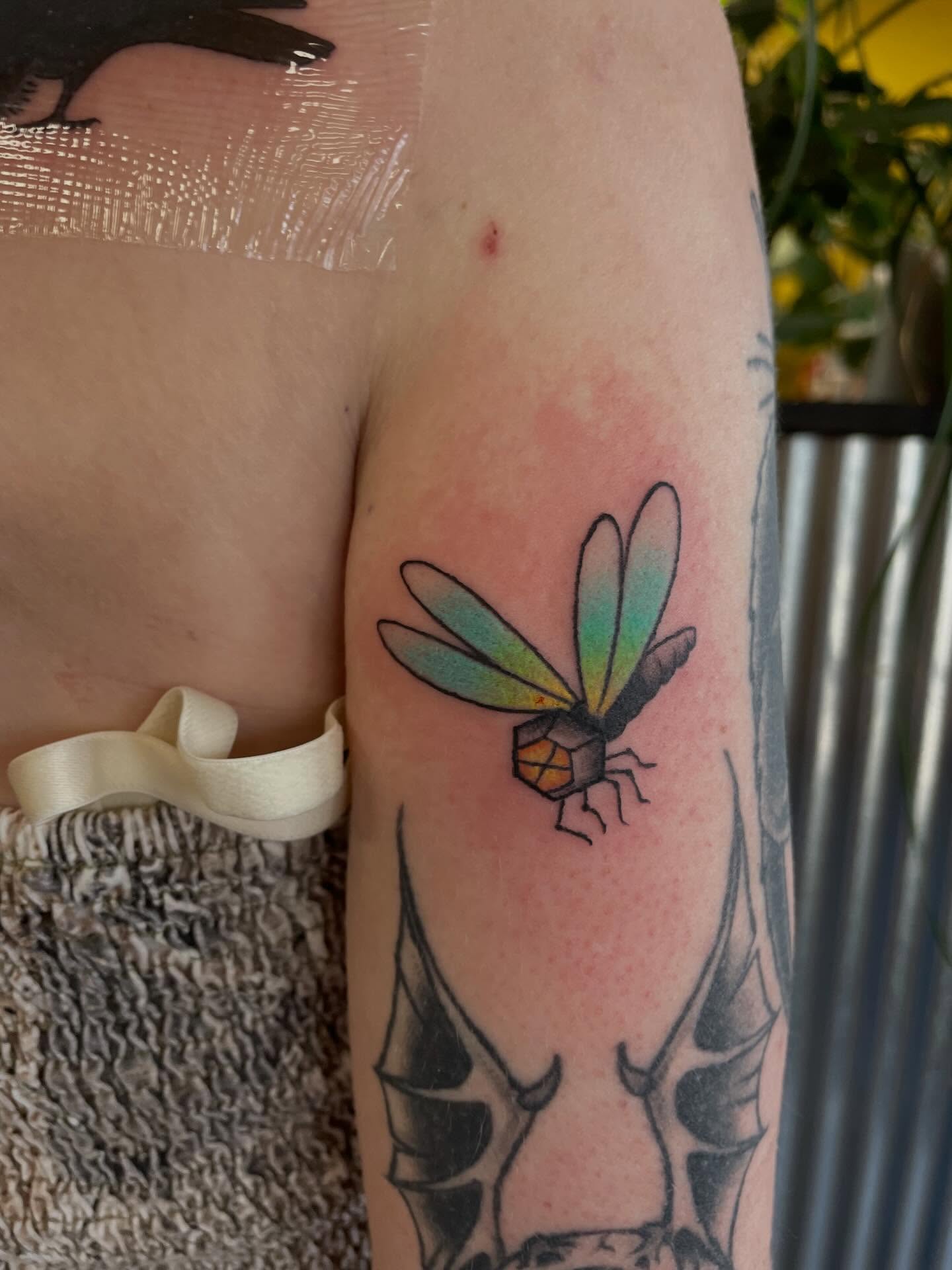 Dragonfly geometric tattoo on the forearm by Mallory Moore