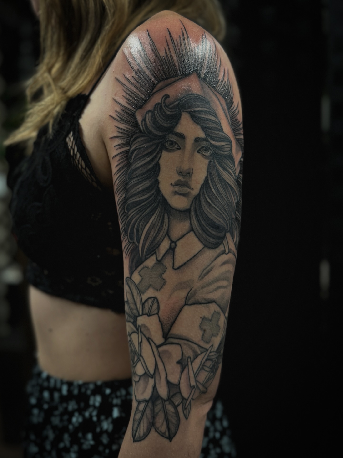 Woman with halo realism tattoo on the upper arm by gina