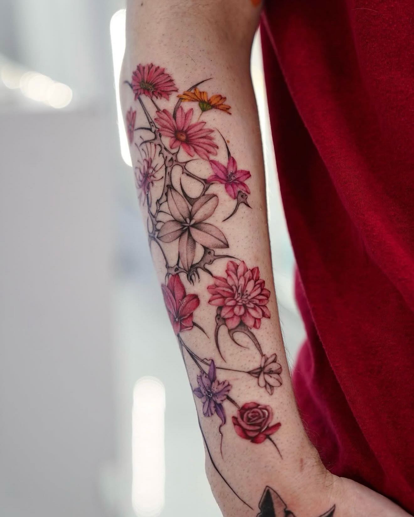 Floral arrangement watercolor tattoo on the forearm by Raytattooist