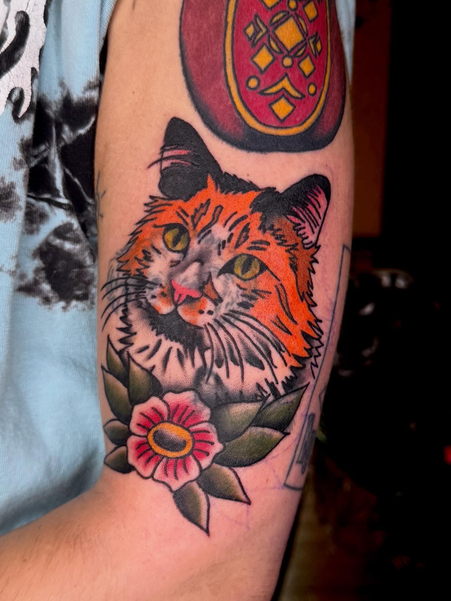 Cat and flowers American traditional tattoo on the forearm by Meg Nefcy, Milford, Michigan
