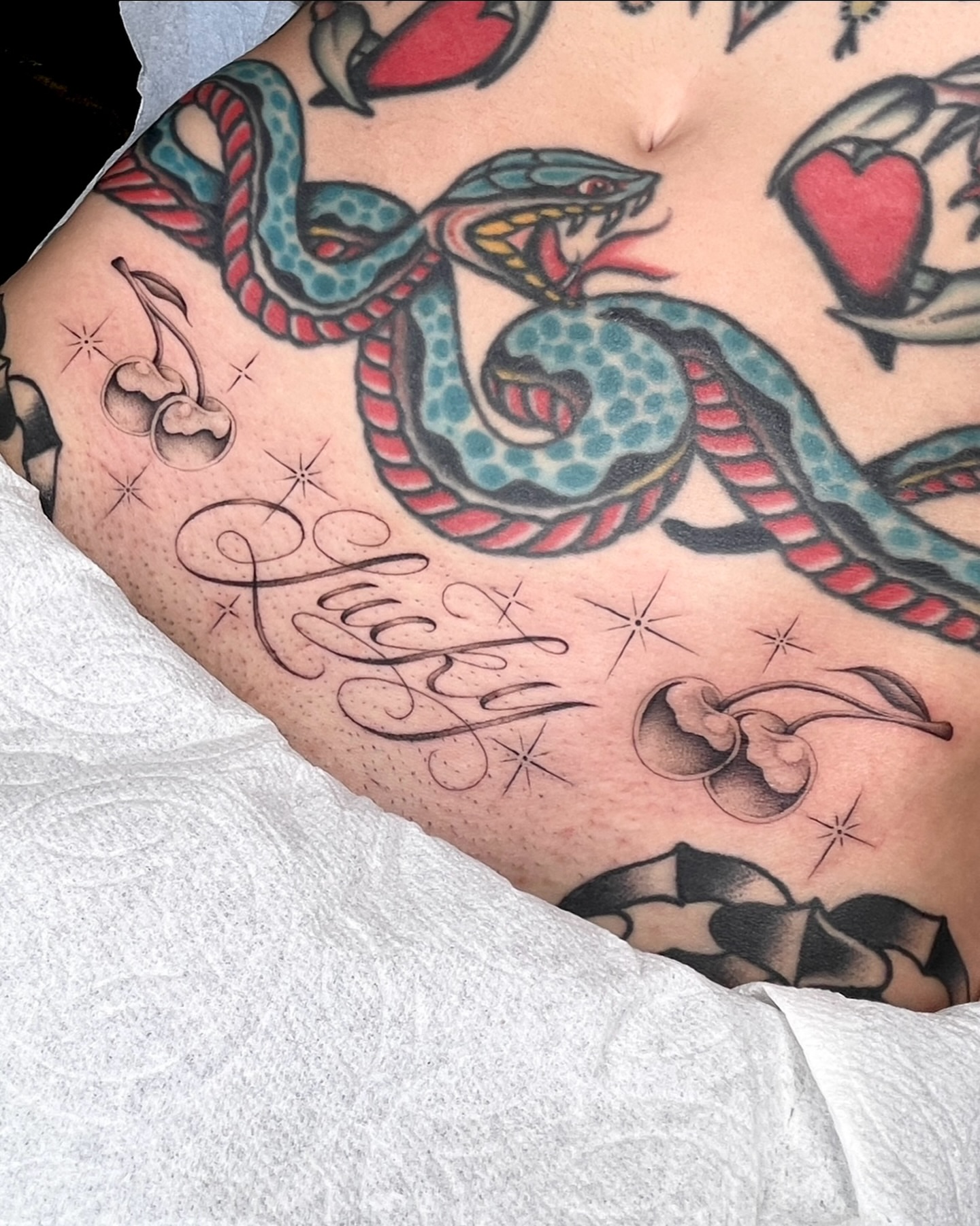 Snake and script American traditional tattoo on the ribs by IVY