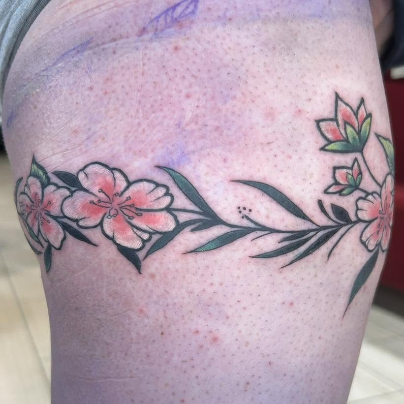Cherry blossoms dotwork tattoo on the thigh by Nino