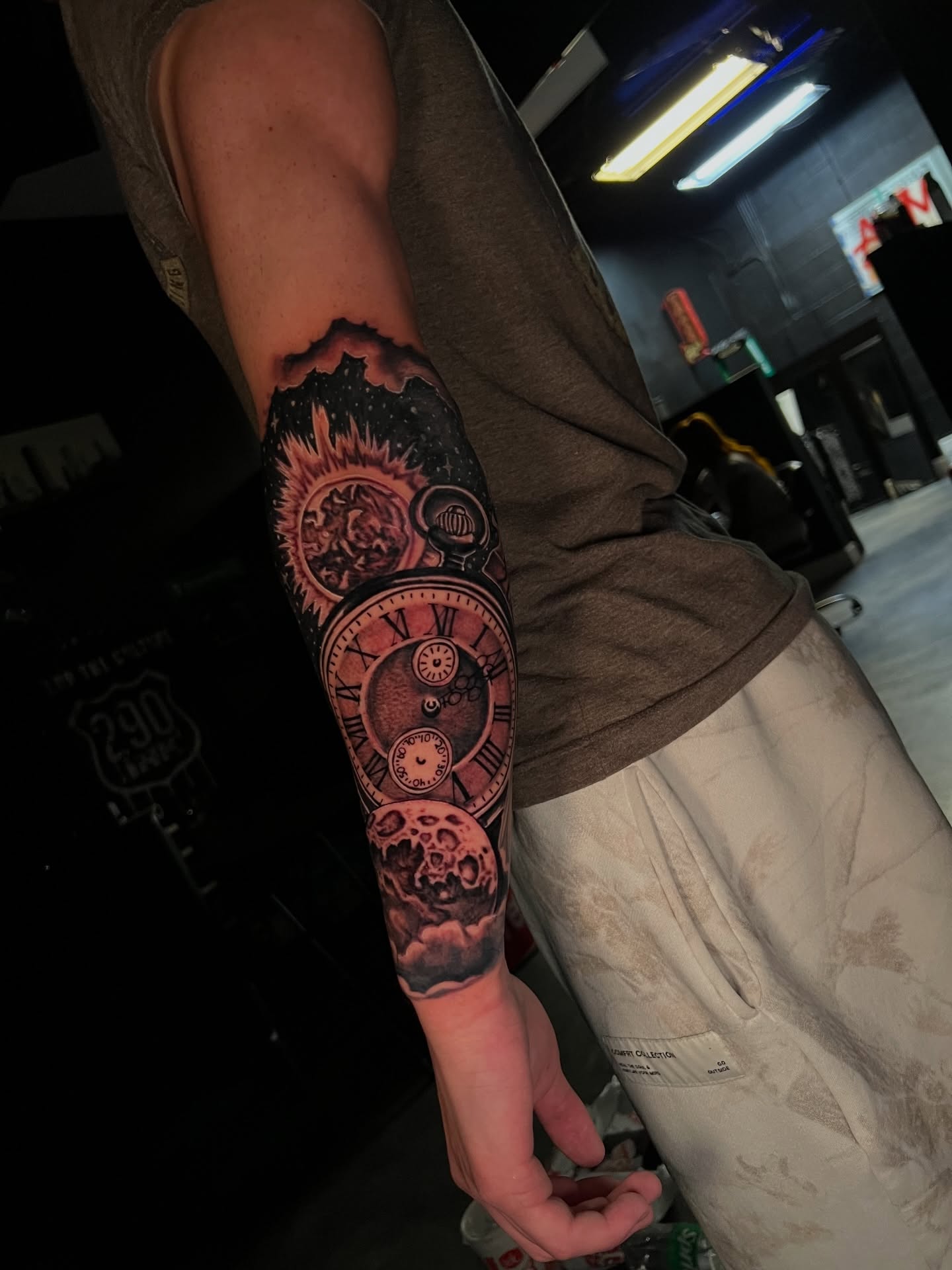 Clock and skull realism tattoo on the forearm by Dee