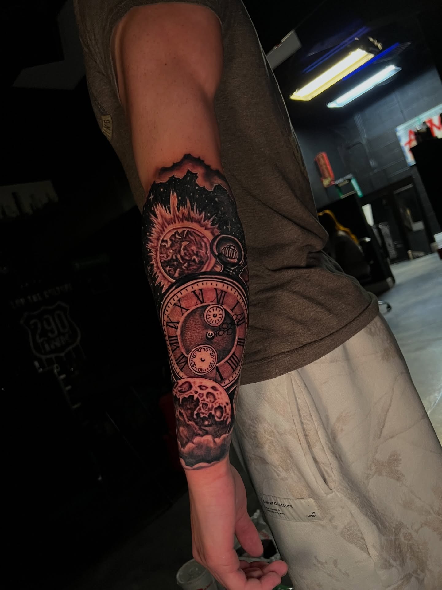 Astronomical clock dark realism tattoo on the forearm by Dee