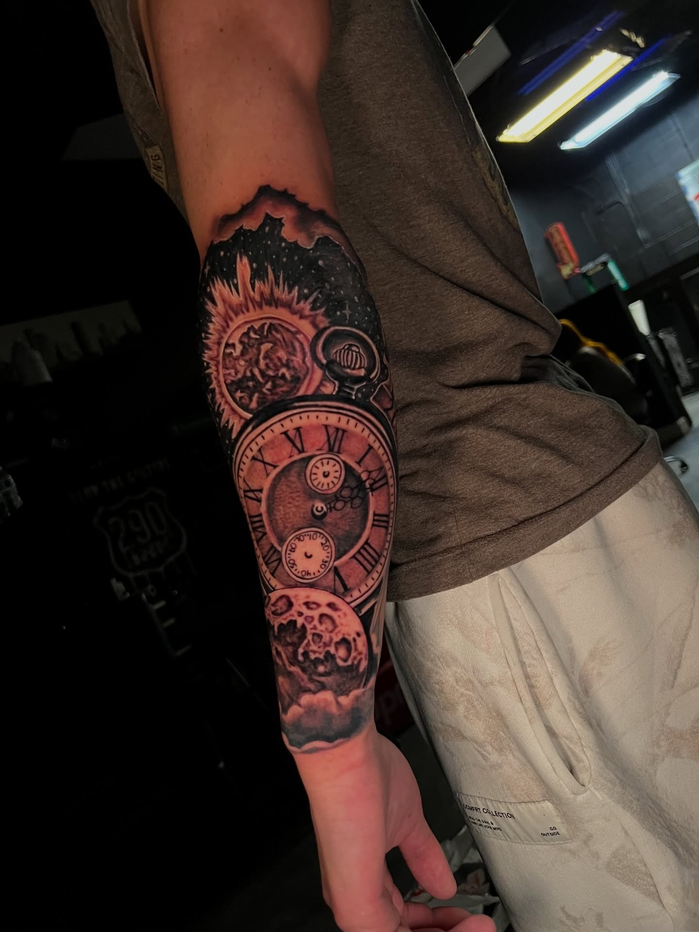 Astronomical clock realism tattoo on the forearm by Dee