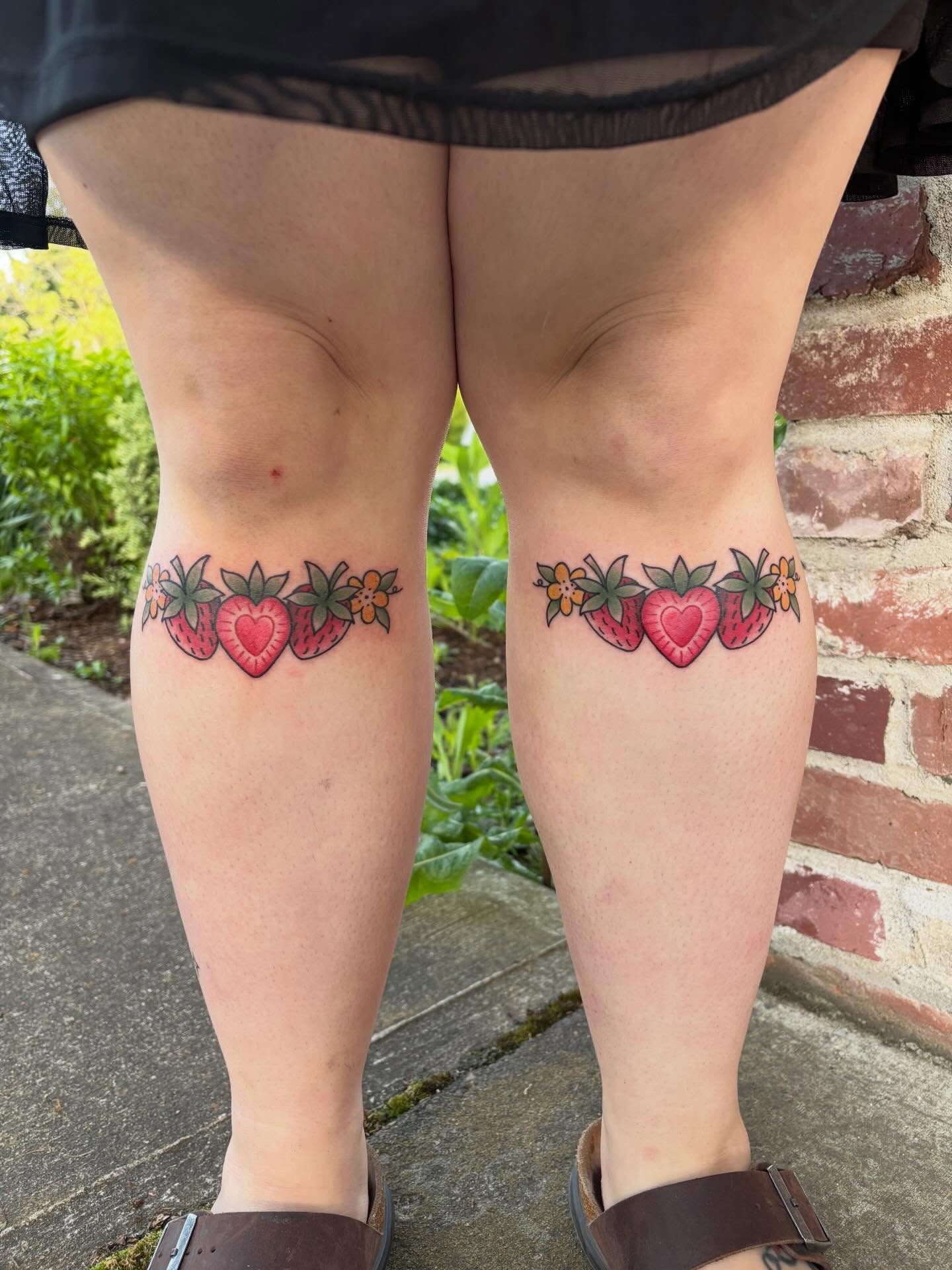 Strawberries and hearts dotwork tattoo on the thigh by Malia Clark