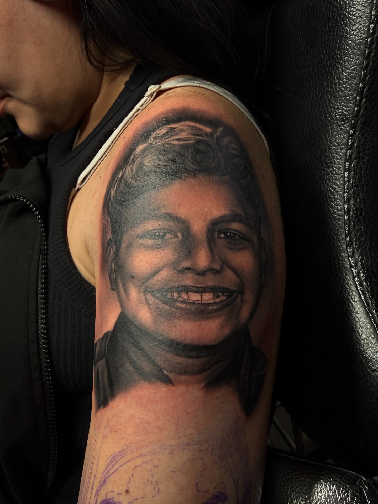 Portrait realism tattoo on the upper arm by Nathan Guerrero