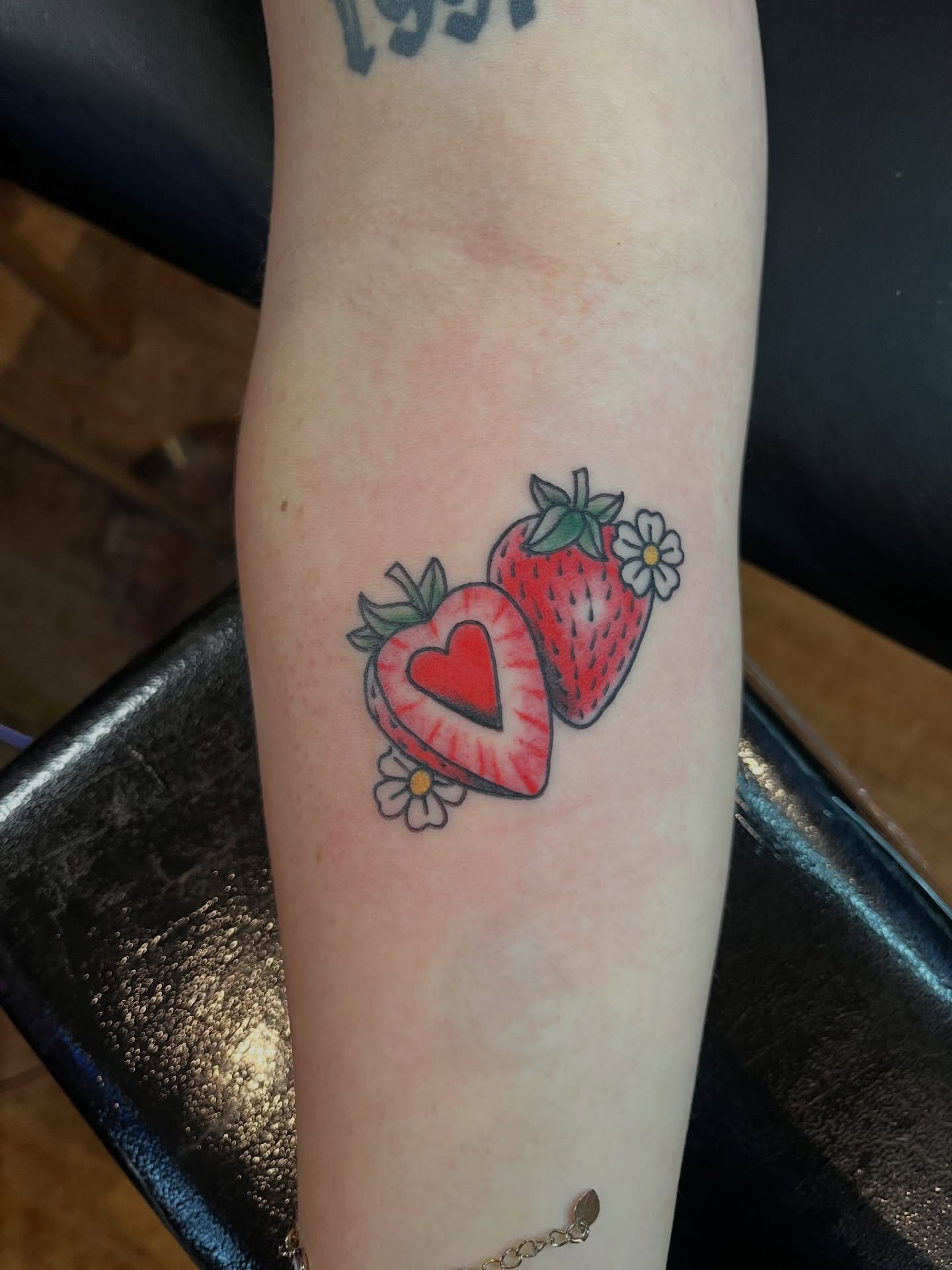 Strawberry heart American traditional tattoo on the forearm by Kimber Teatro, Portland, Oregon