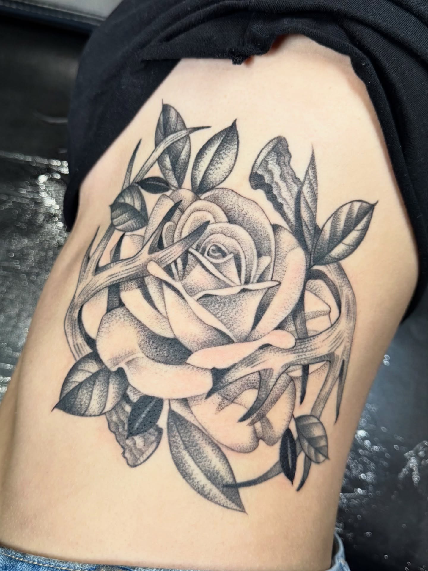 Rose black and grey tattoo on the thigh by Miles Romero Smith