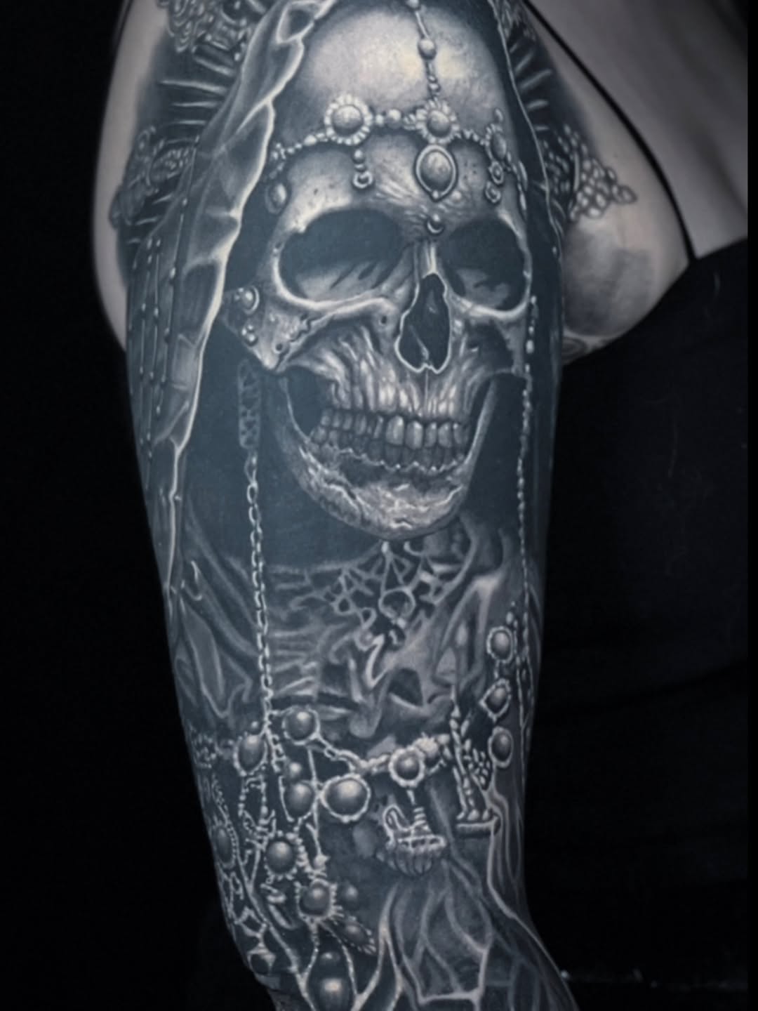 Skull with jewelry realism tattoo on the forearm by Gabriel Londis