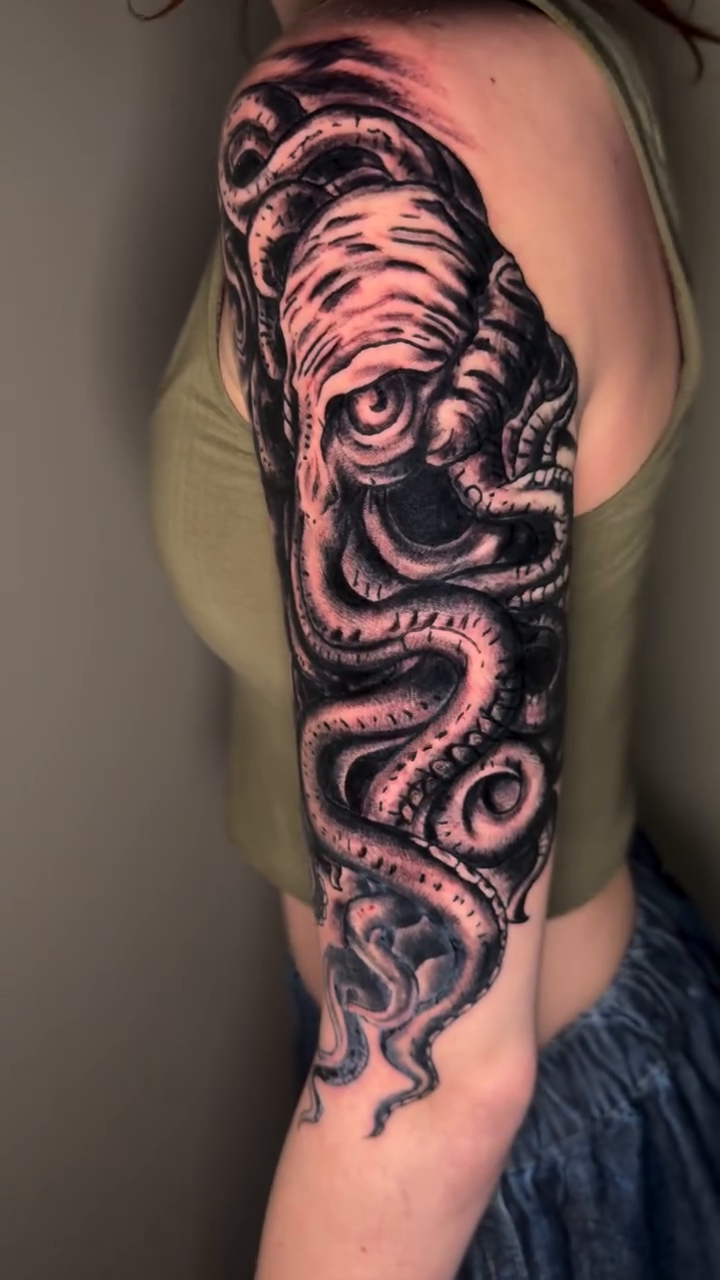 Octopus sleeve realism tattoo on the upper arm by spikecitytattoo