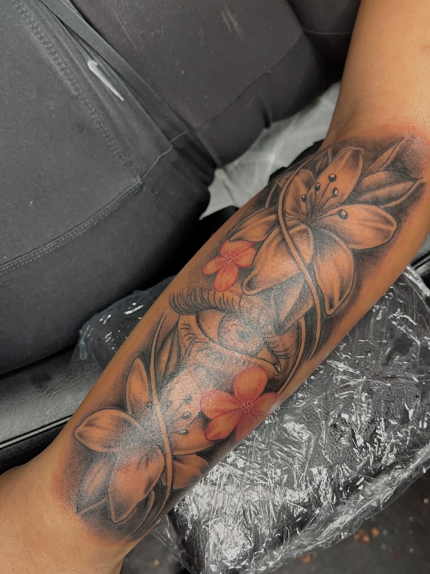 Floral arrangement realism tattoo on the forearm by The inspo