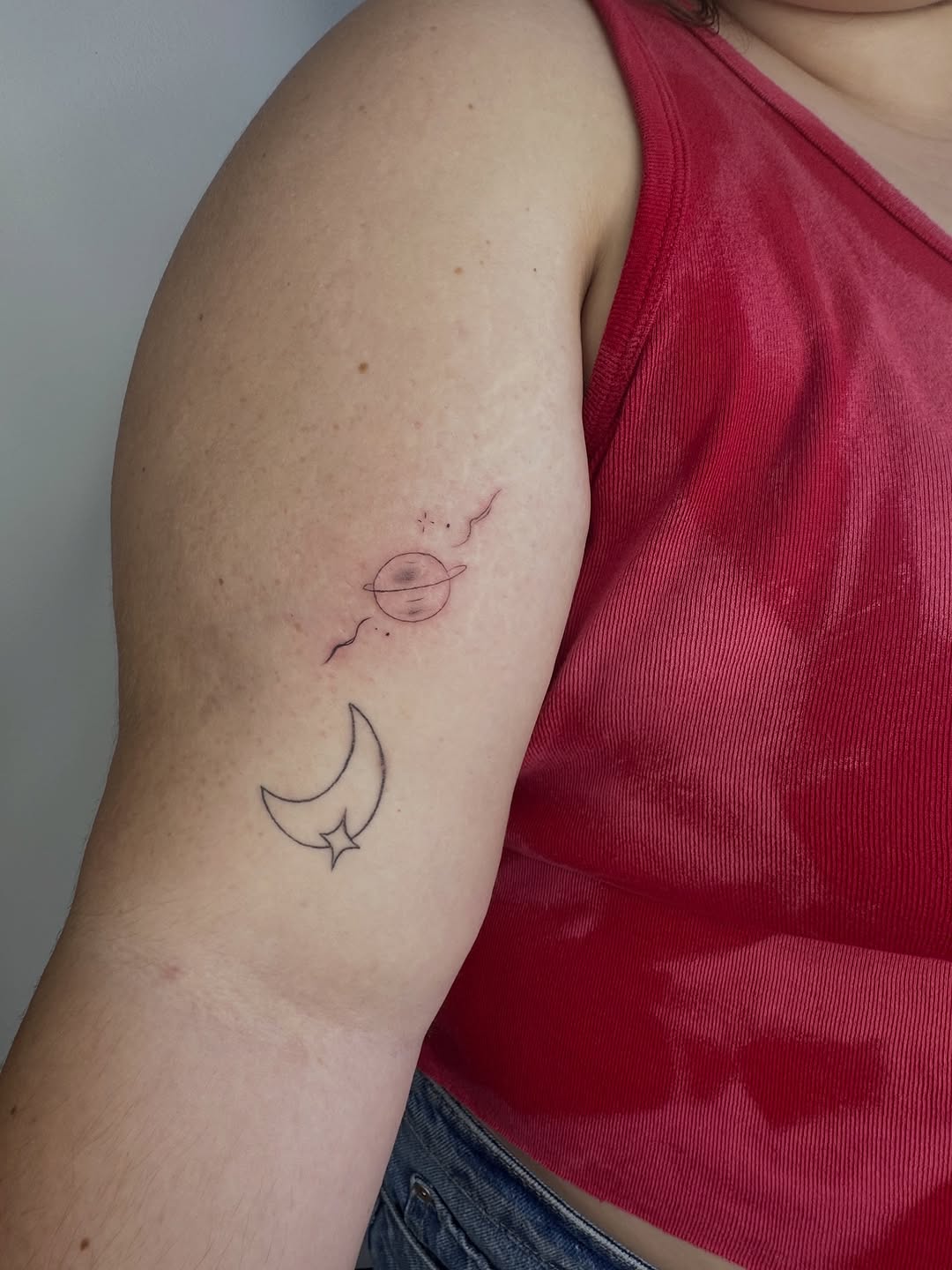 Planet and moon with star minimalist tattoo on the upper arm by Cherry🥀
