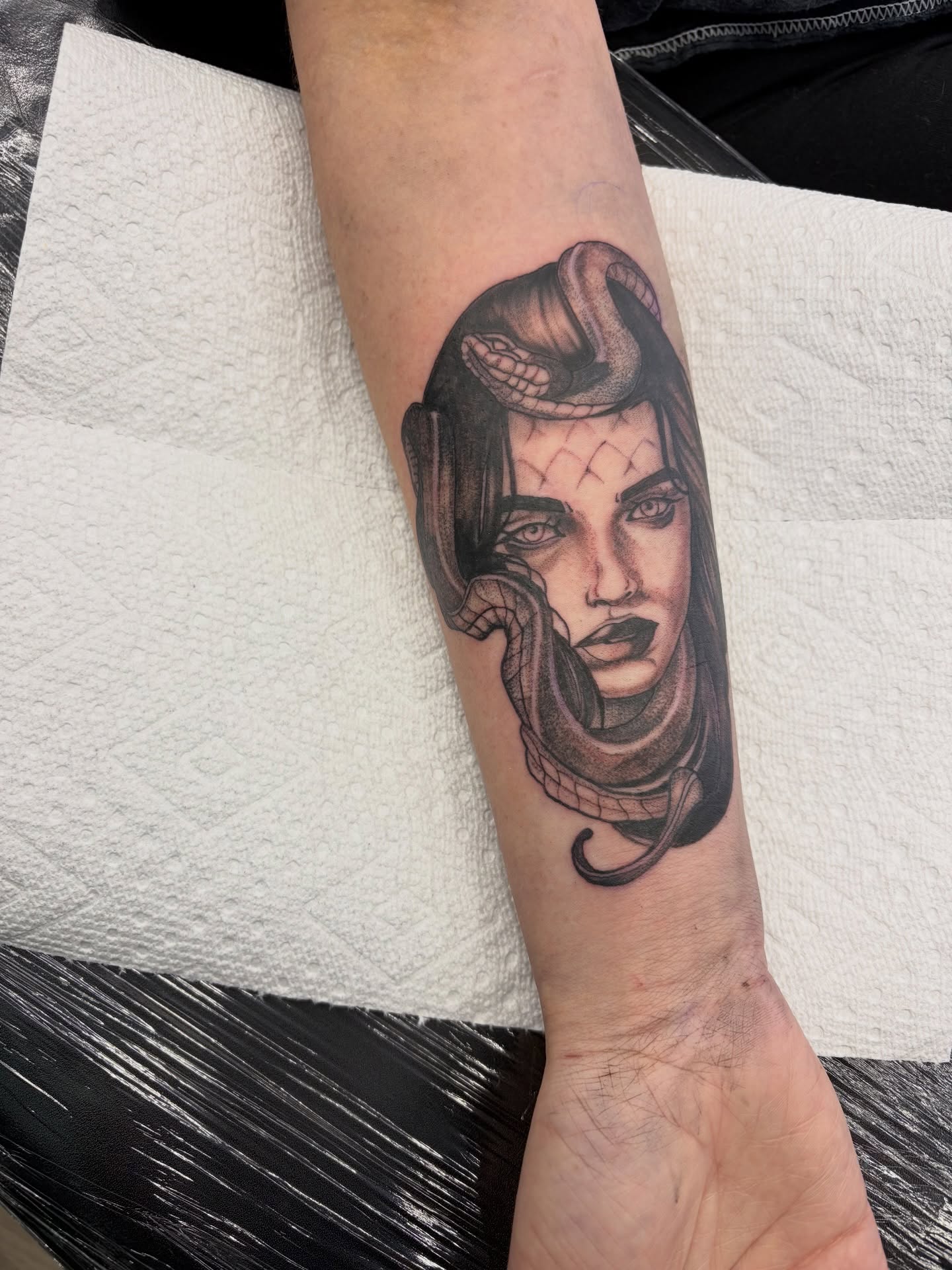 Woman with snake realism tattoo on the forearm by Calen Copeland