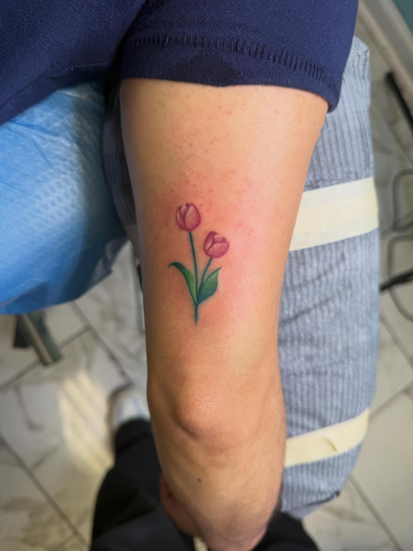 Tulips watercolor tattoo on the forearm by linda perez