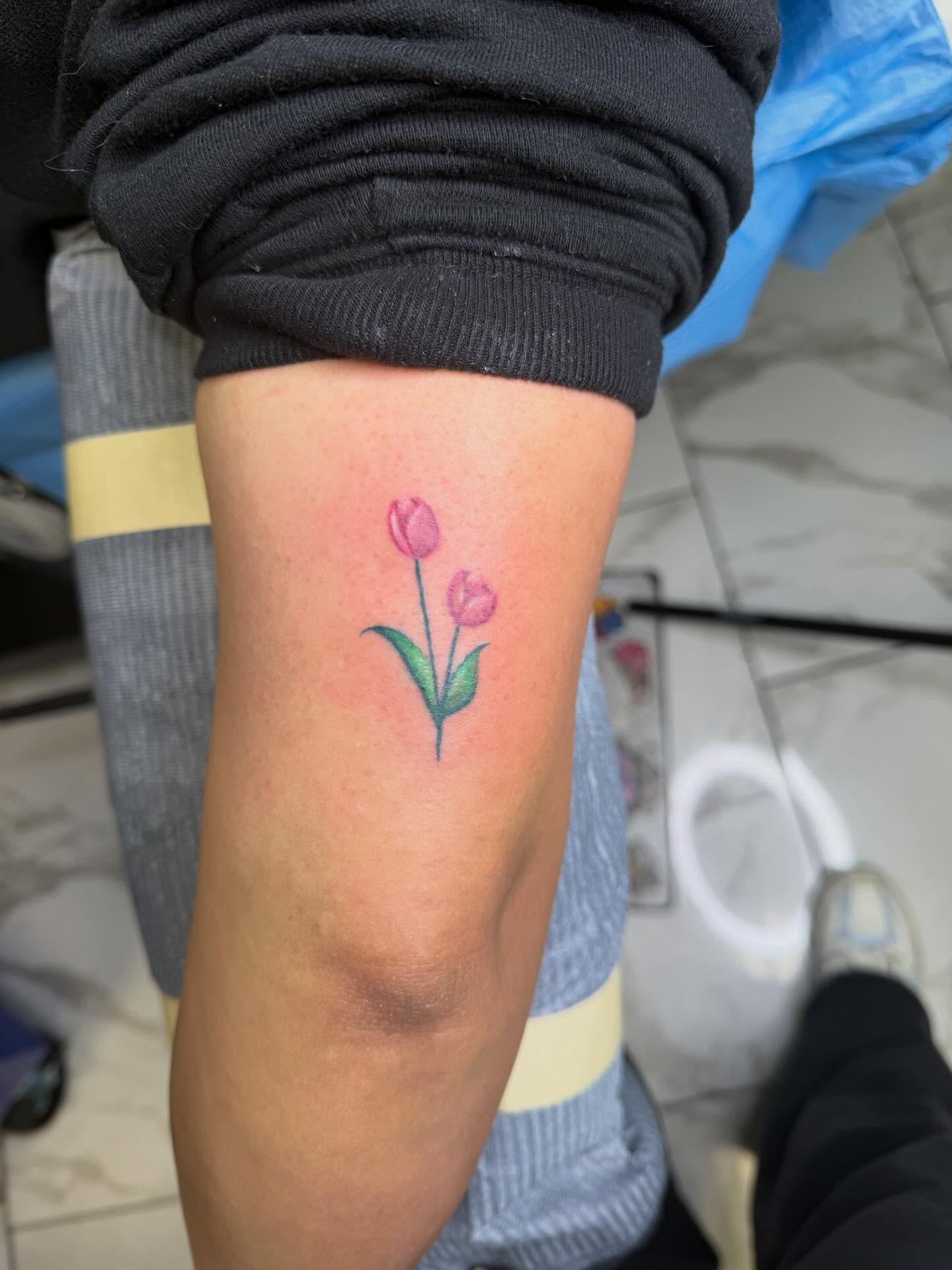 Tulips watercolor tattoo on the forearm by linda perez