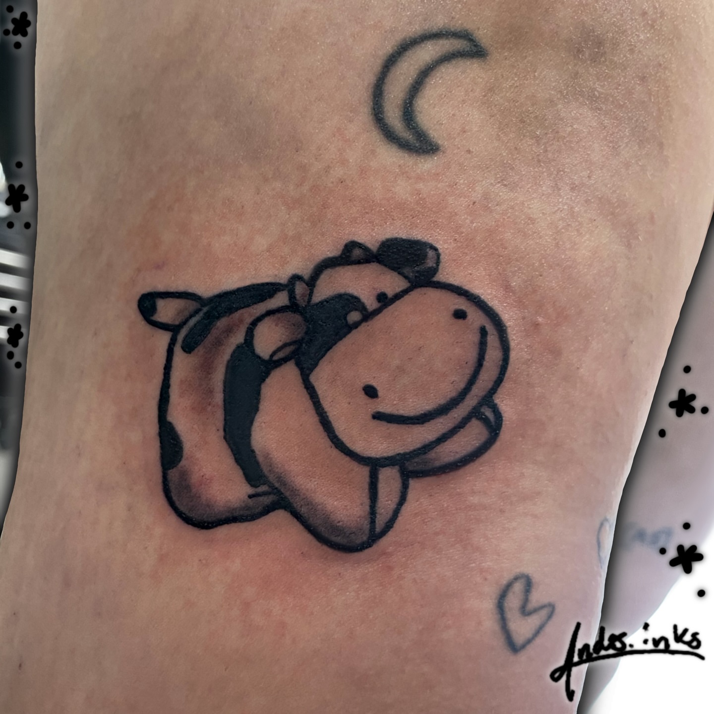 Cow black and grey tattoo on the thigh by ande
