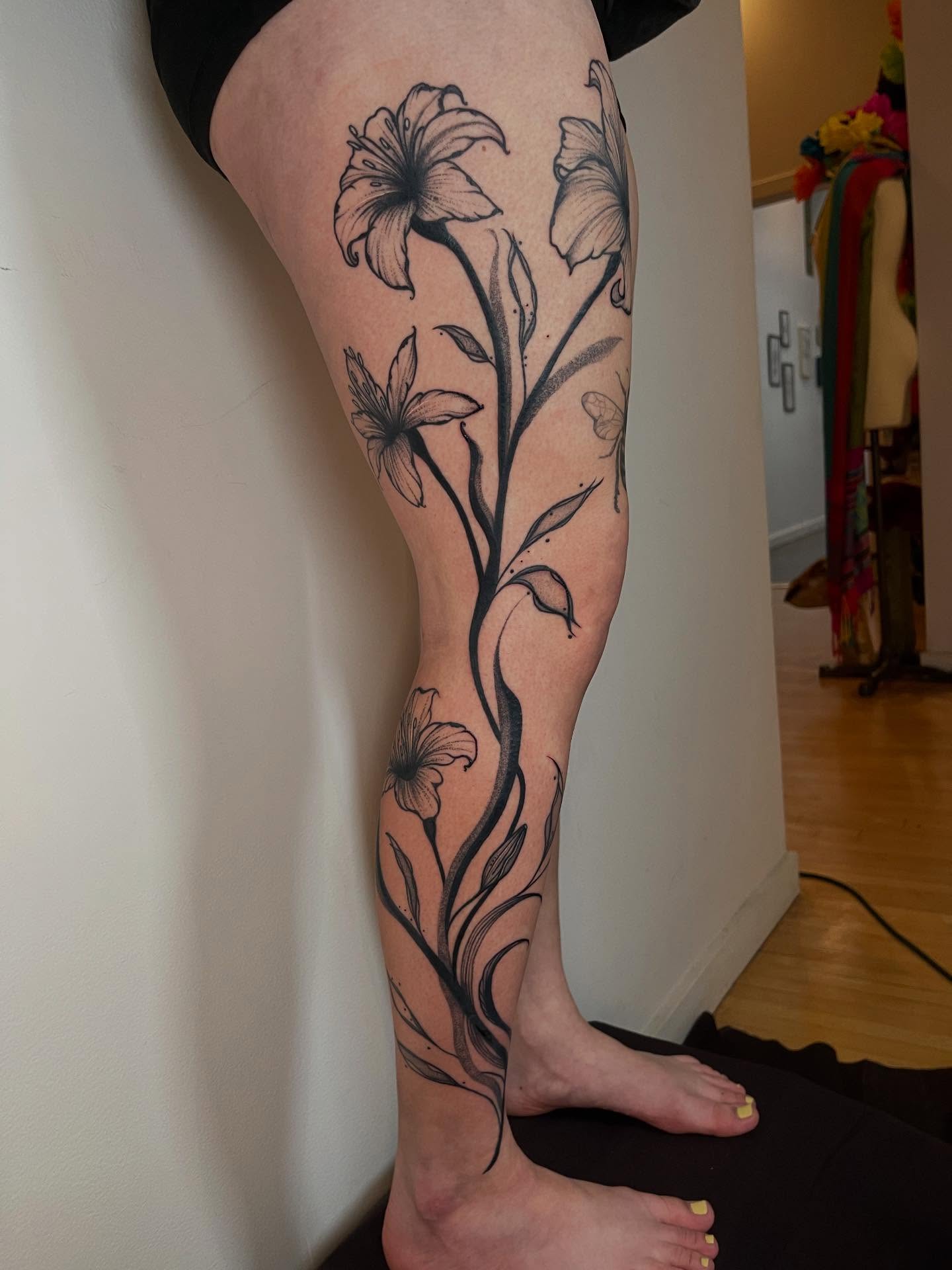 Lily flowers black and grey tattoo on the calf by Elisa