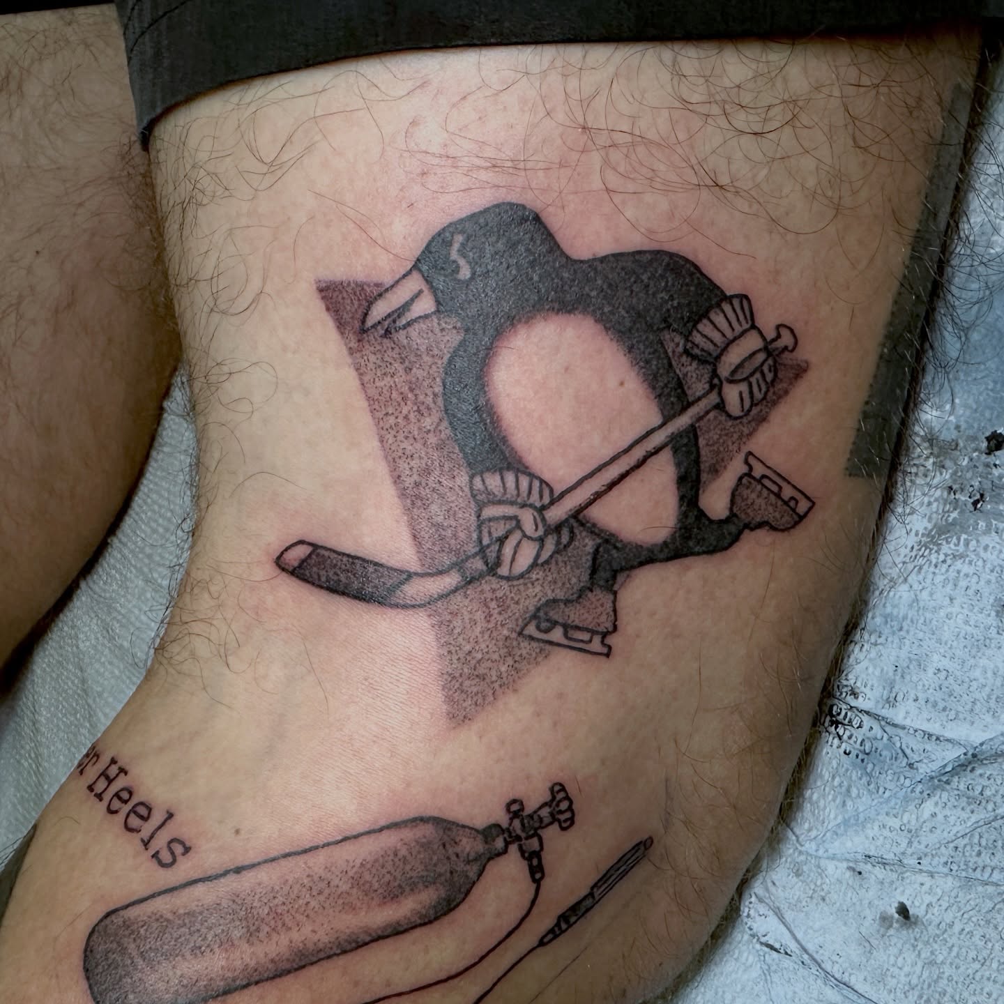 Hockey penguin dotwork tattoo on the thigh by Luisa Gonzalez, Austin, Texas