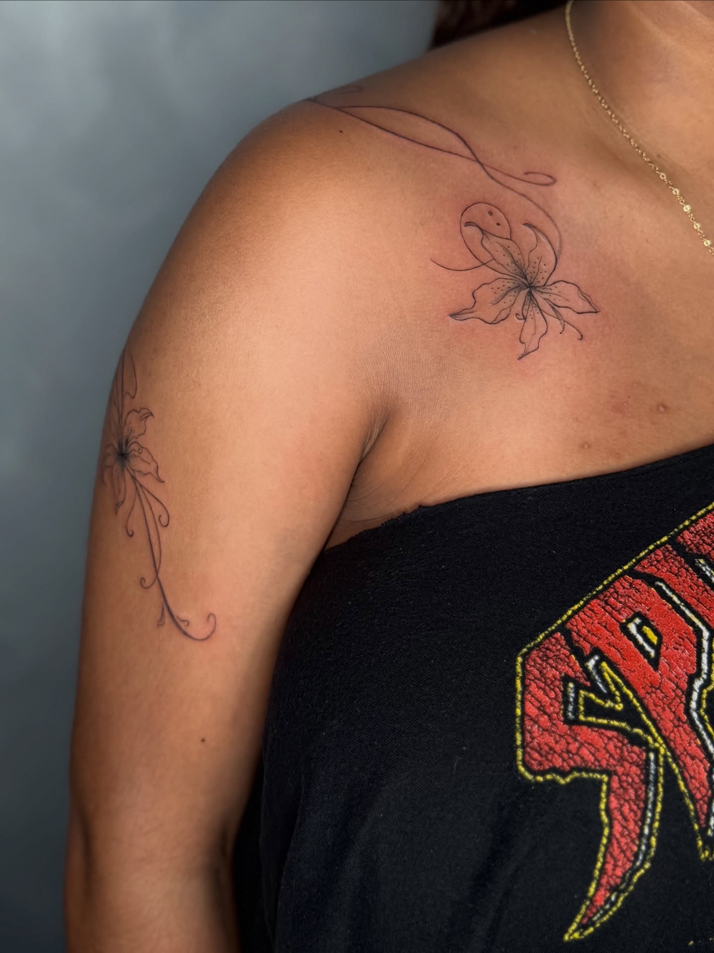 Flower fine line tattoo on the shoulder by DFW Fineline Tattoo Artist
