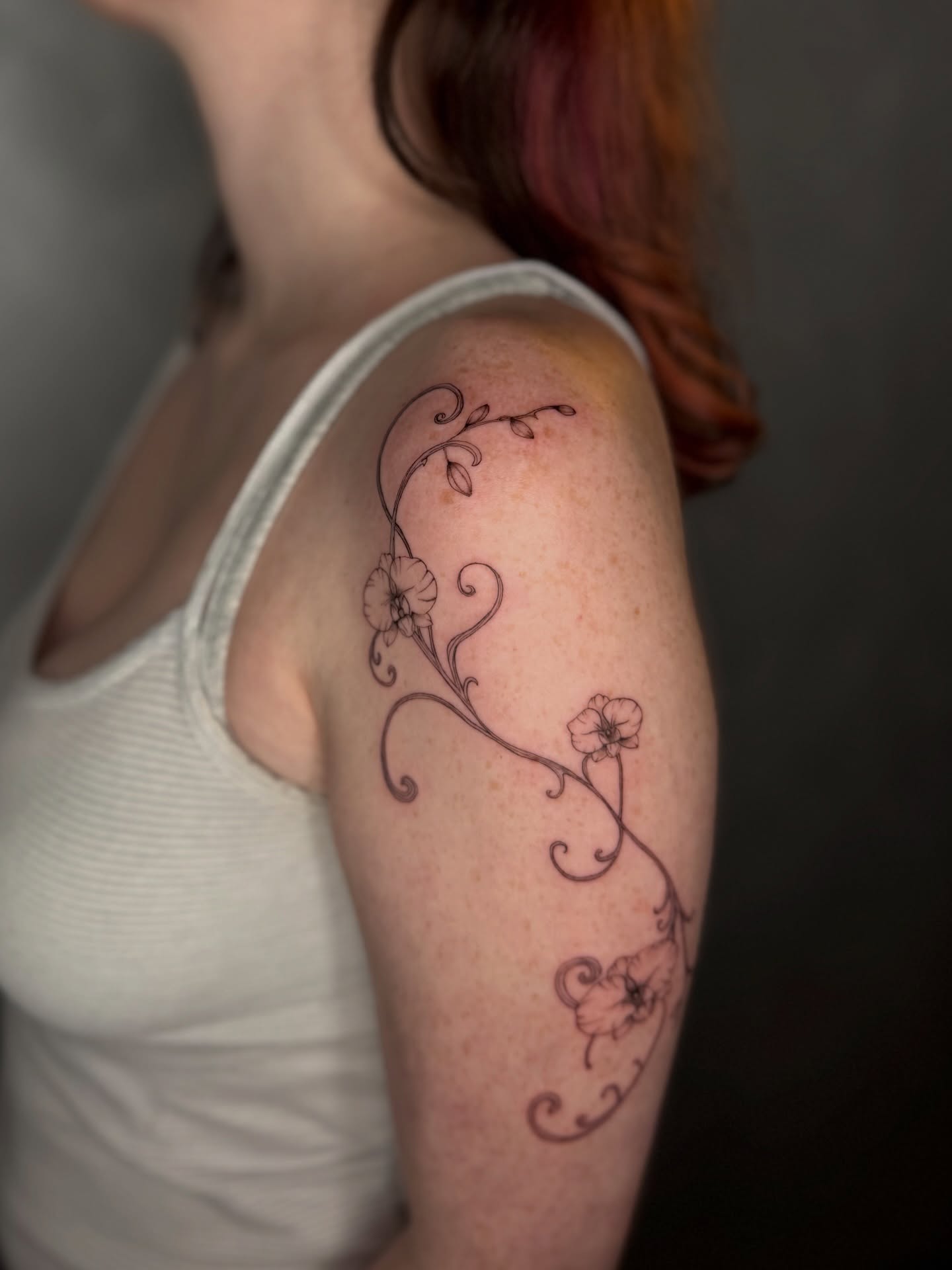 Floral vine fine line tattoo on the shoulder by DFW Fineline Tattoo Artist