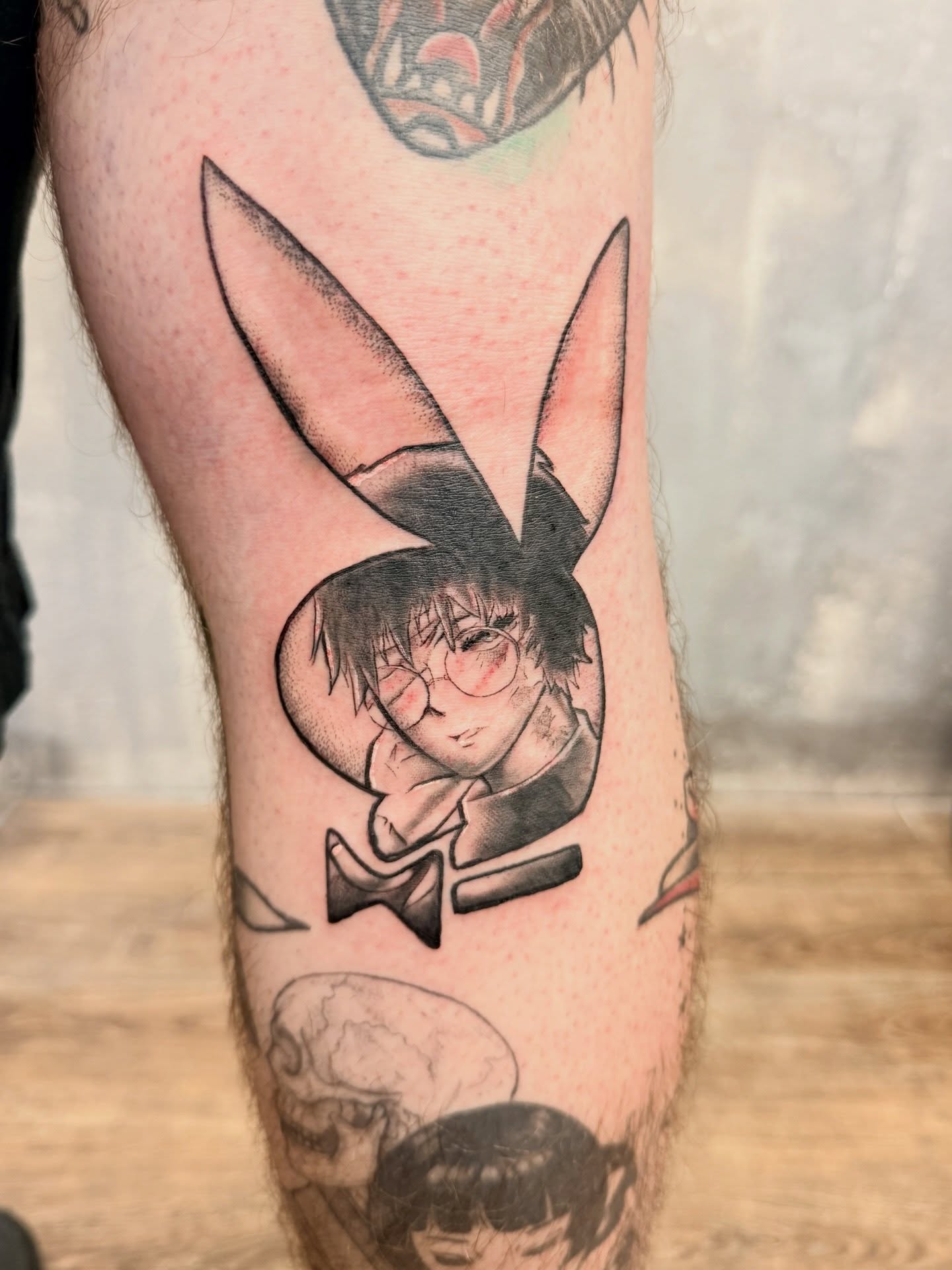 Playboy bunny character black and grey tattoo on the forearm by Chris
