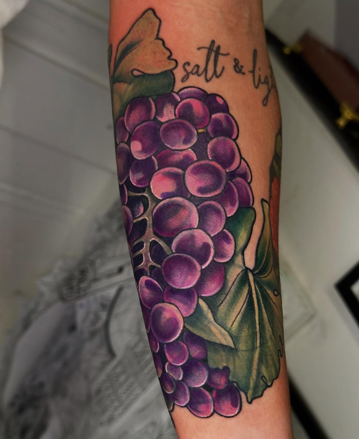 Grapes American traditional tattoo on the forearm by 𝕳𝖆𝖓𝖓𝖆𝖍 𝕮𝖆𝖓𝖋𝖎𝖊𝖑𝖉 ✨ Memphis Tattoo Artist, Memphis, Tennessee