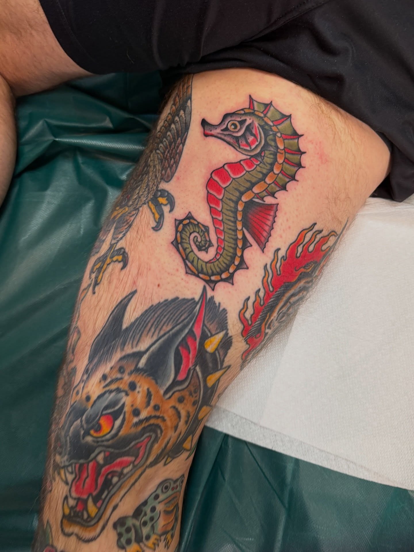 Seahorse and dragon American traditional tattoo on the thigh by Christopher Mikesell