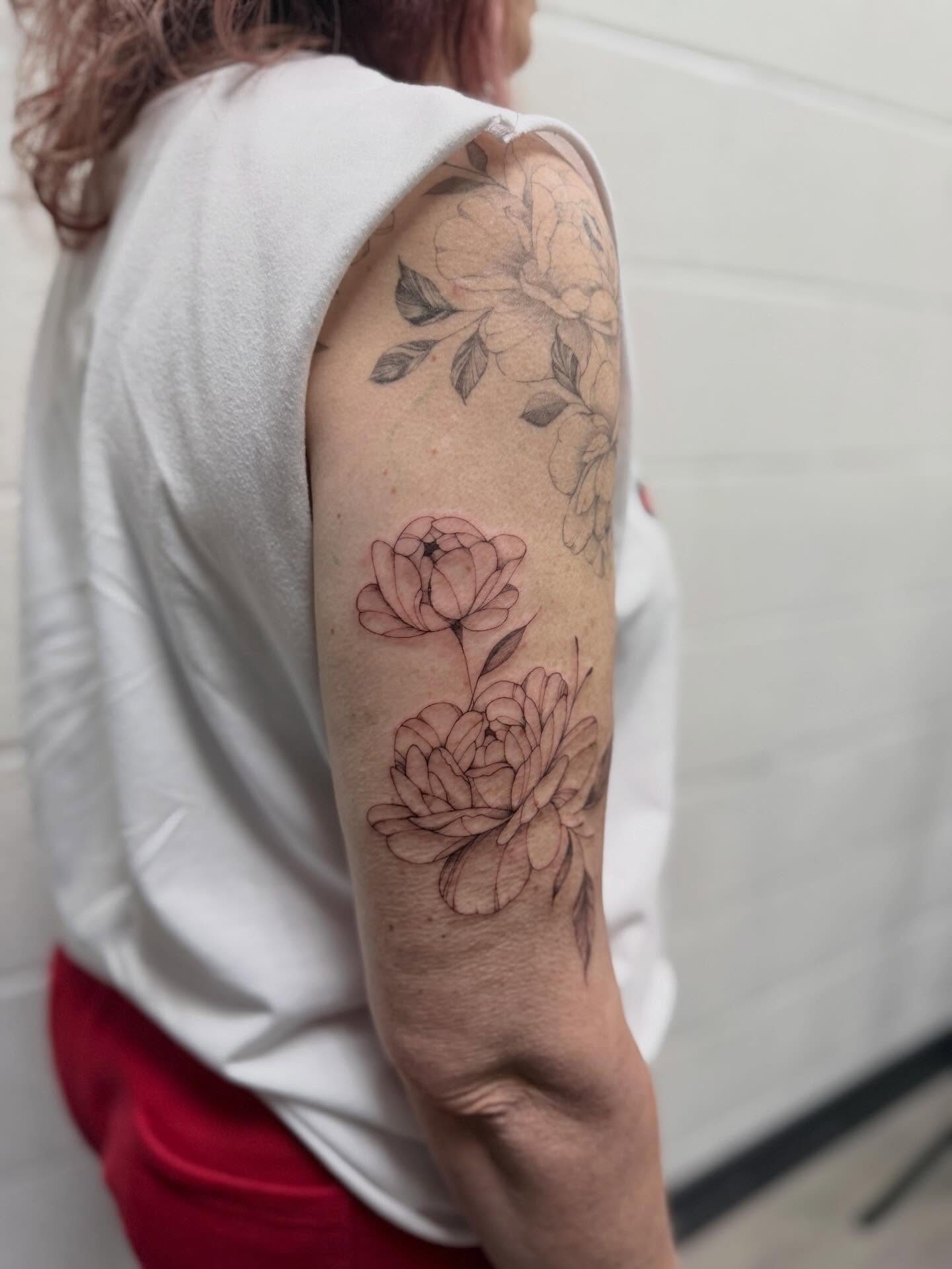 Peony flowers black and grey tattoo on the forearm by Reverie Studio