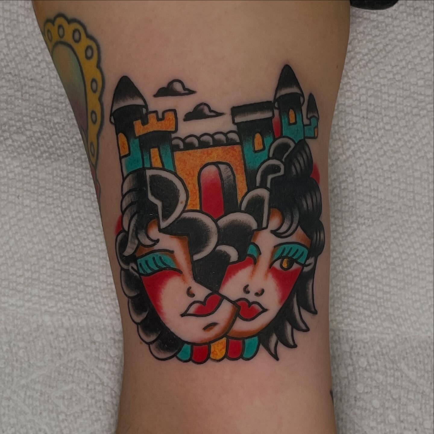 Castle and faces American traditional tattoo on the forearm by Rizzo