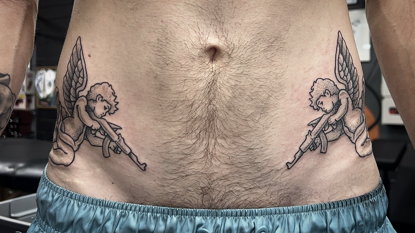 Angels with guns black and grey tattoo on the torso by 𝑴𝒂𝒚𝒂𖤐𝑫𝒆𝑽𝒊𝒏𝒆, Dayton, Ohio