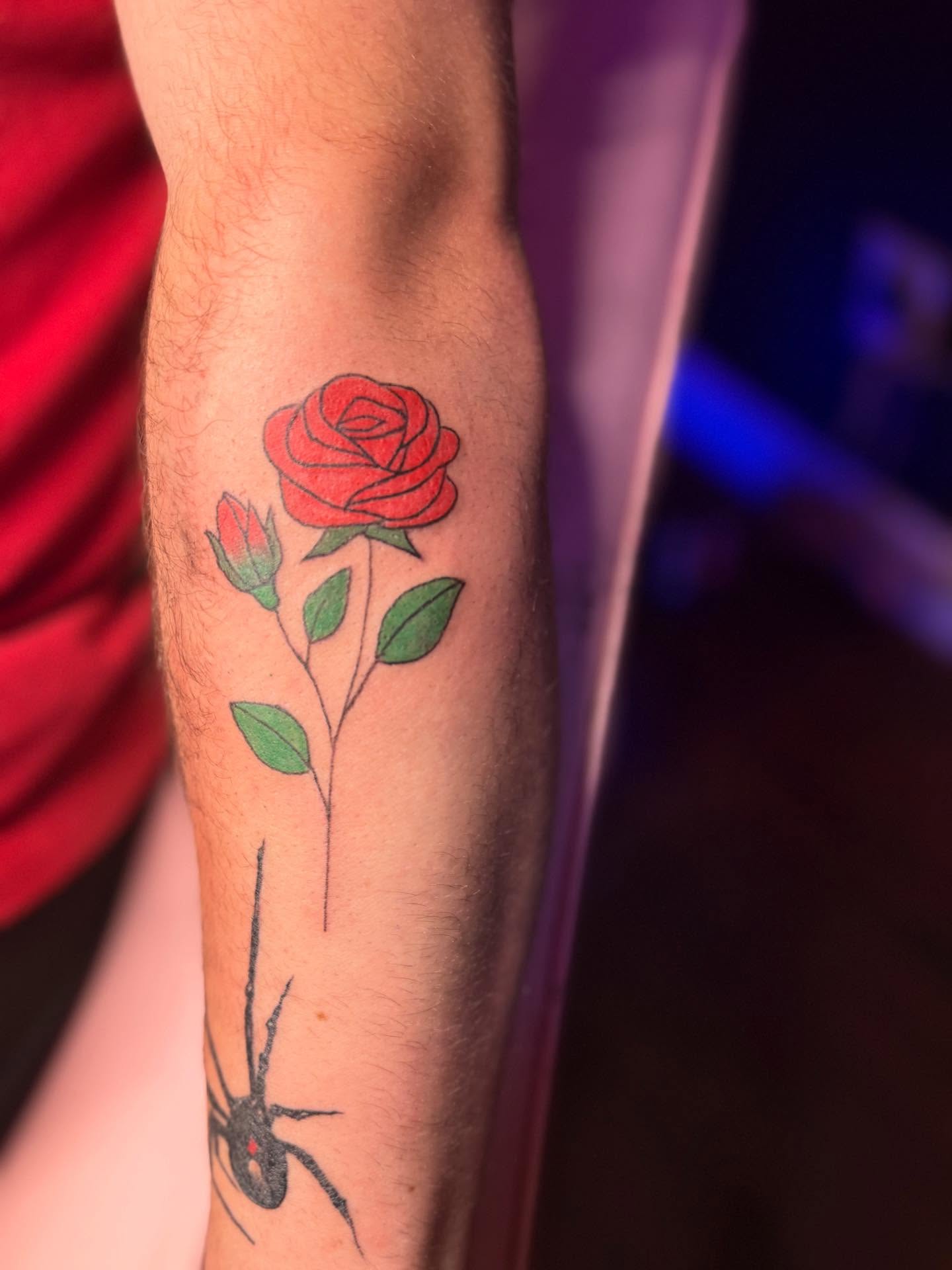 Rose and spider realism tattoo on the forearm by Tattoos by Santos