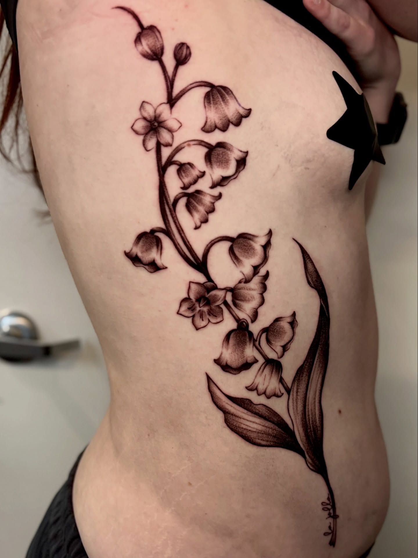 Lily of the valley black and grey tattoo on the ribs by ˖.𖥔 ݁˖anna hoffman˖ ⊹ ࣪ ˖, Salt Lake City, Utah