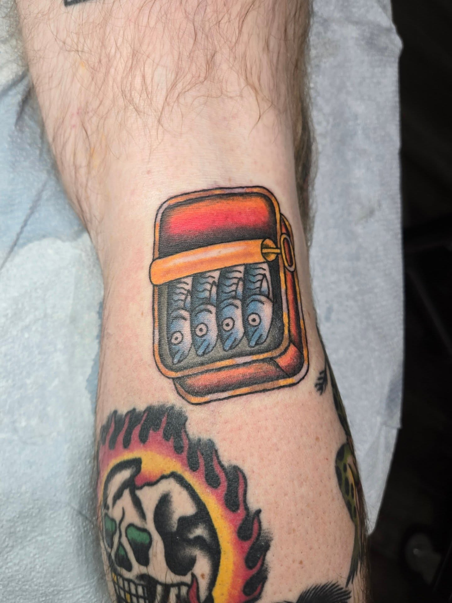 Canned fish American traditional tattoo on the forearm by Matt Page