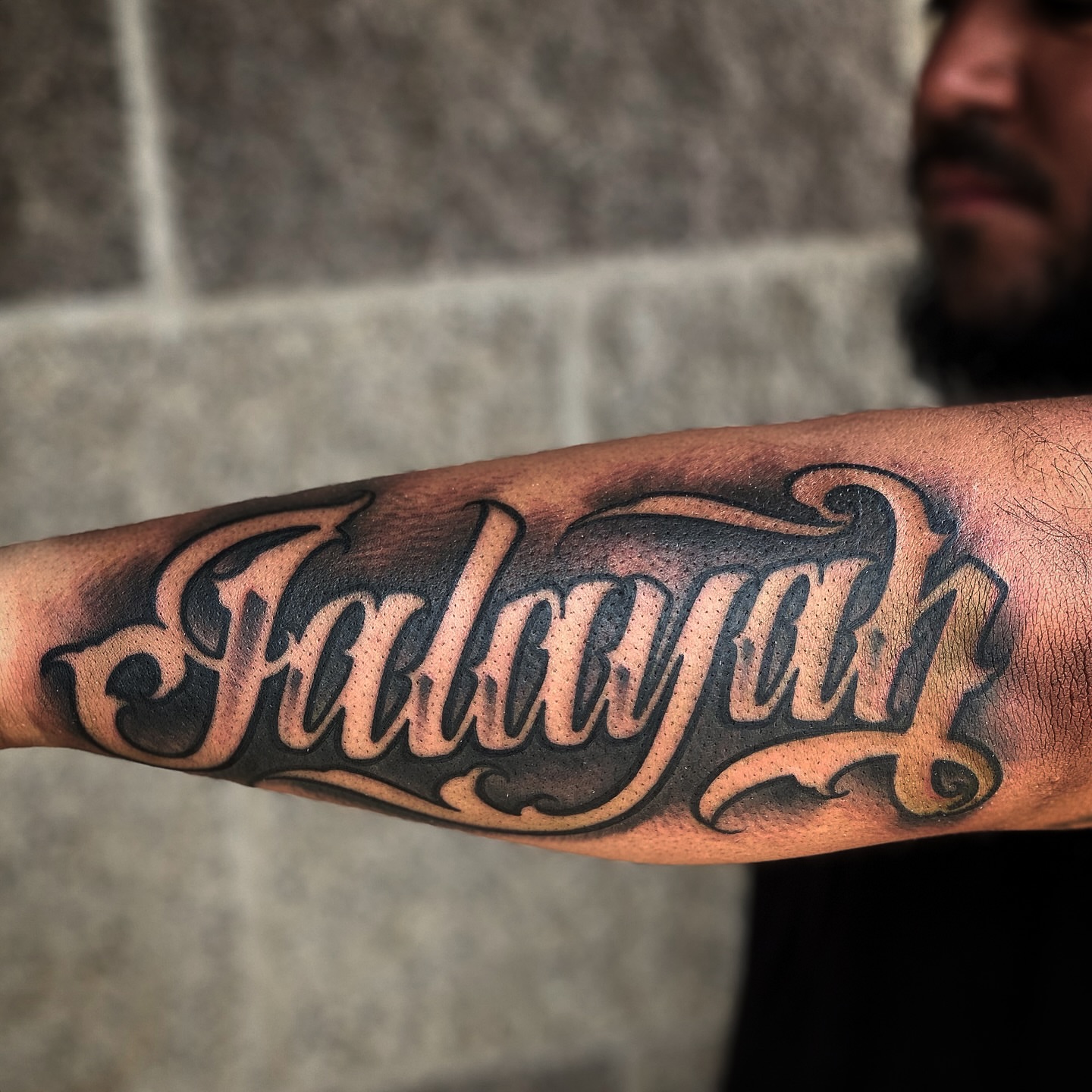 Falayjah lettering script tattoo on the forearm by Lex Miranda