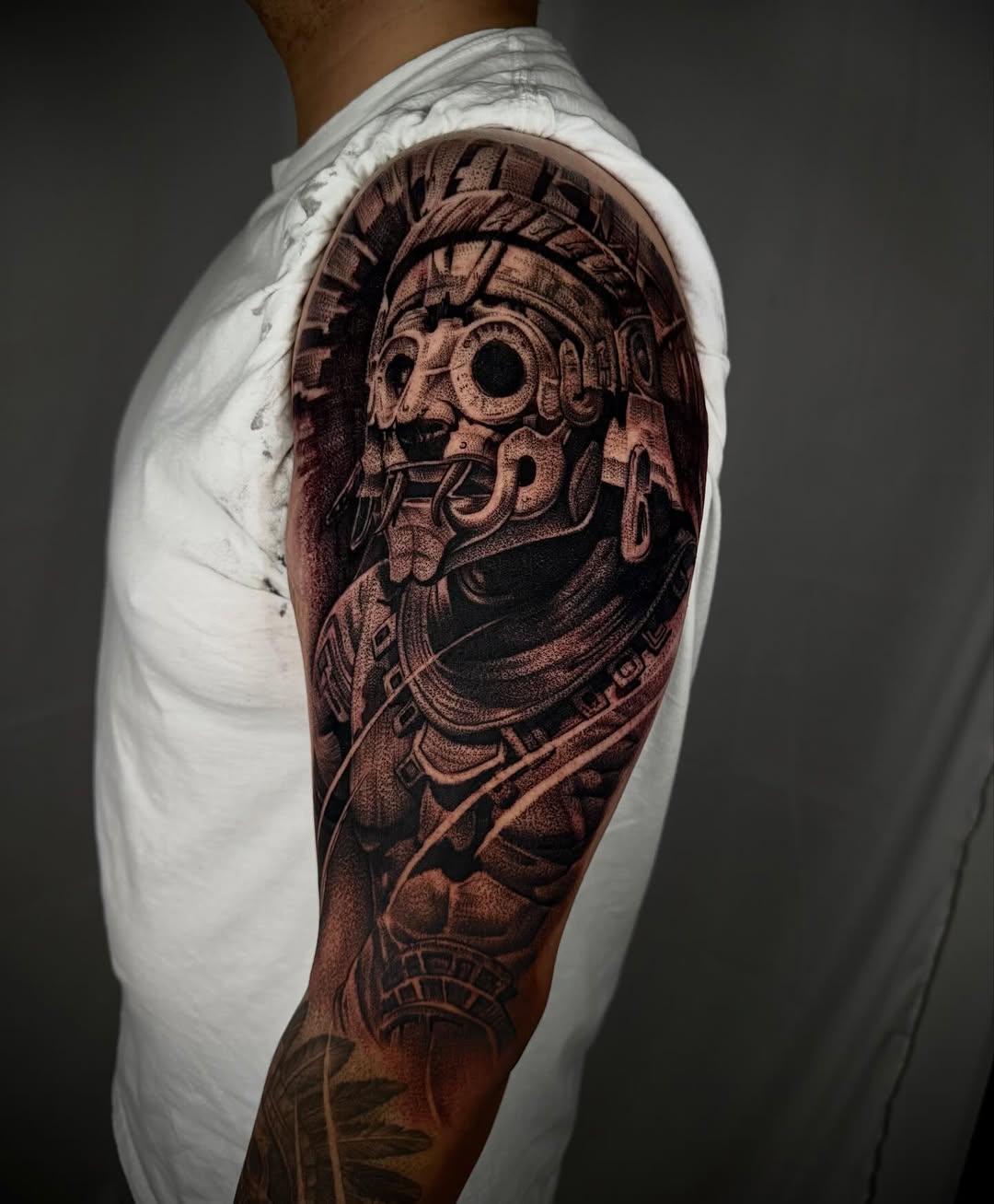 Mayan warrior mask realism tattoo on the upper arm by DREW ROMERO - Colorado Tattoo Artist, Pueblo, Colorado