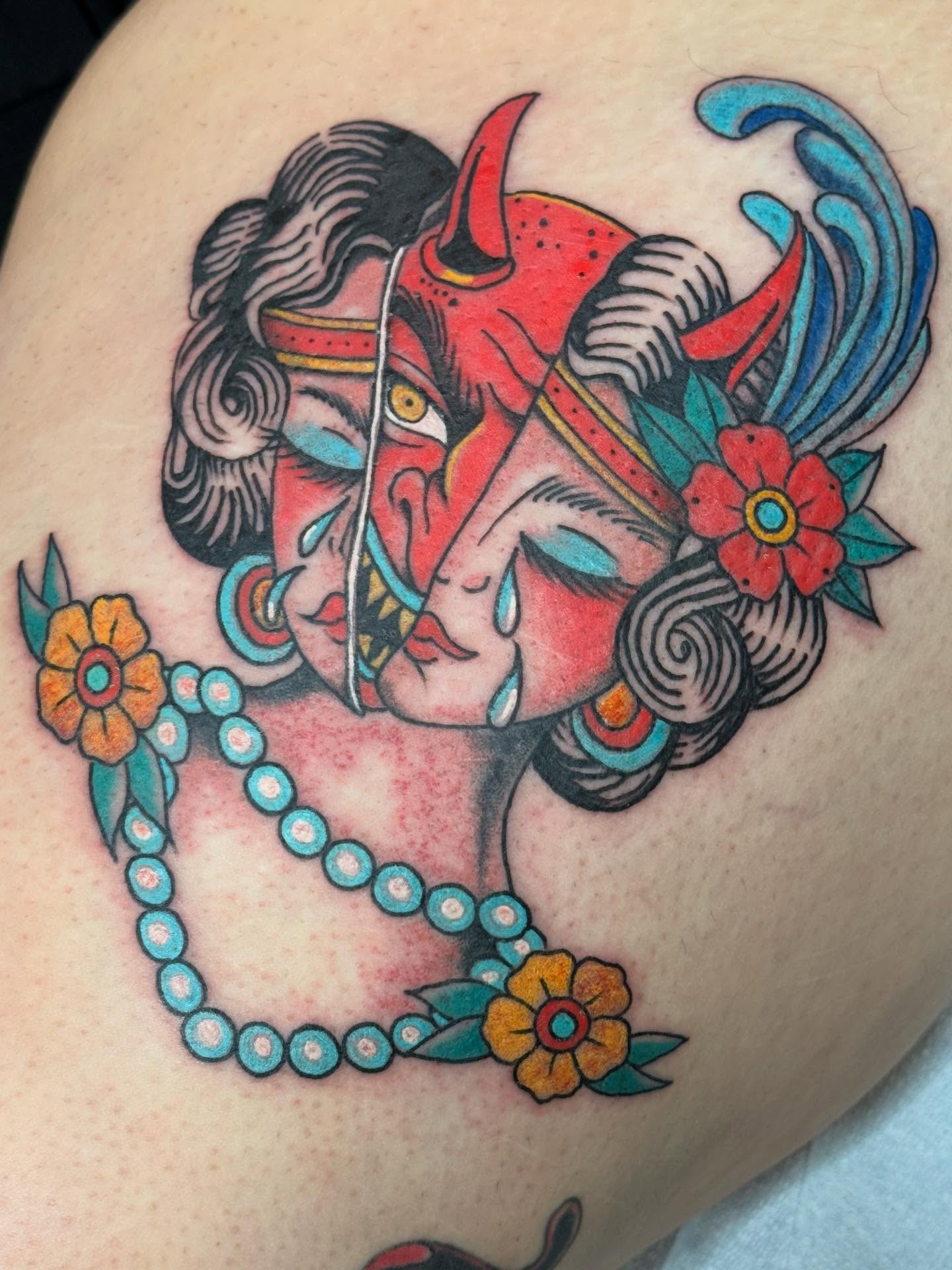 Woman with horns American traditional tattoo on the thigh by Megan Sue Causemaker