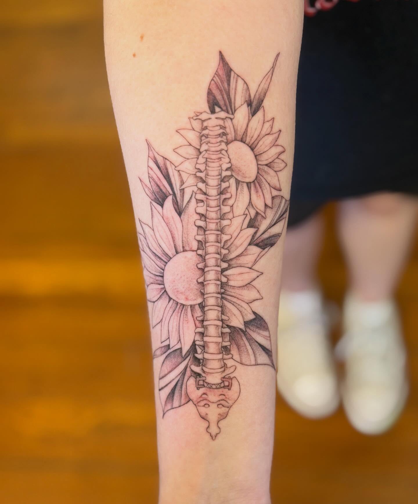 Spine with sunflowers realism tattoo on the forearm by Raul Najera Tattoo, Plano, Texas