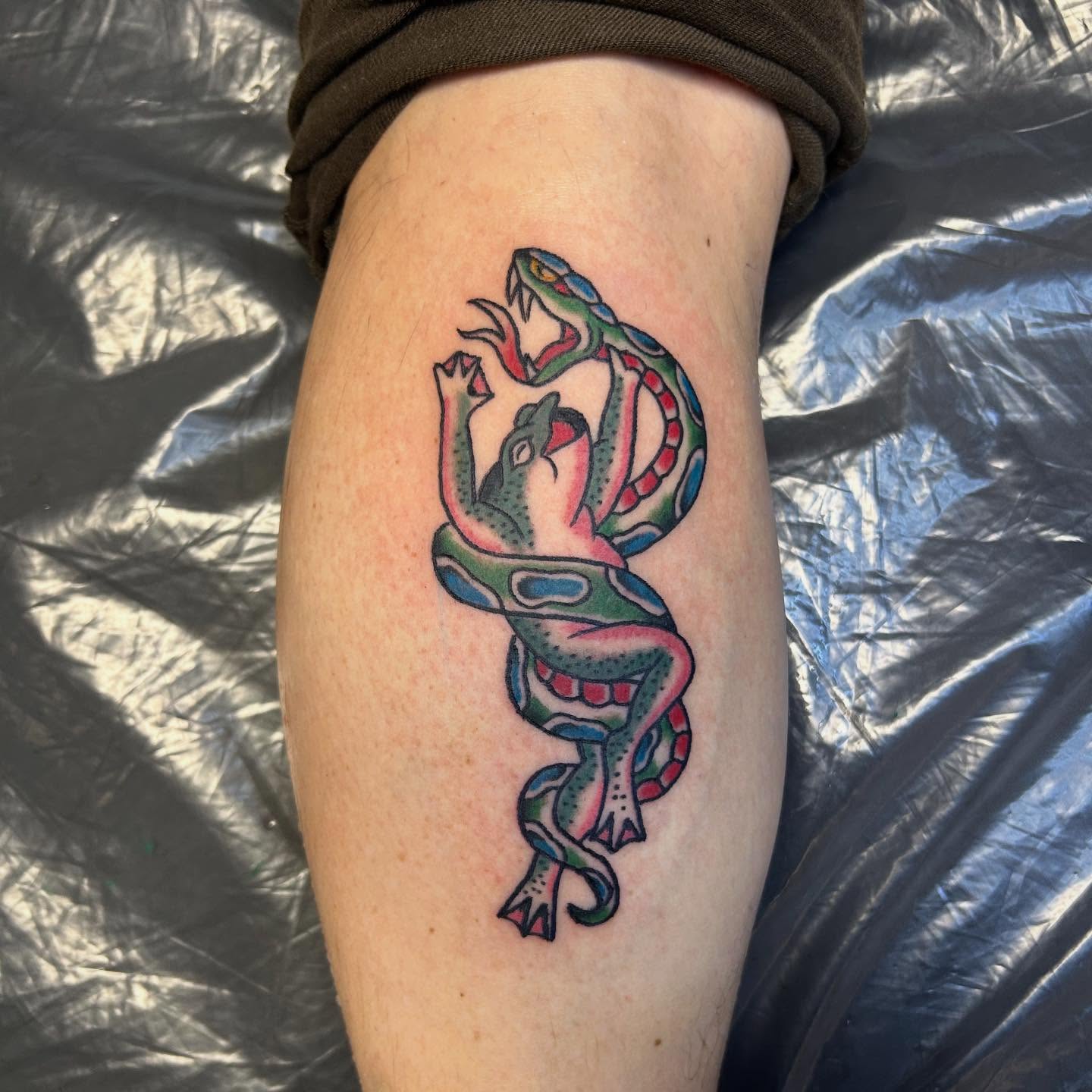Snake and frog American traditional tattoo on the forearm by Randy Bray