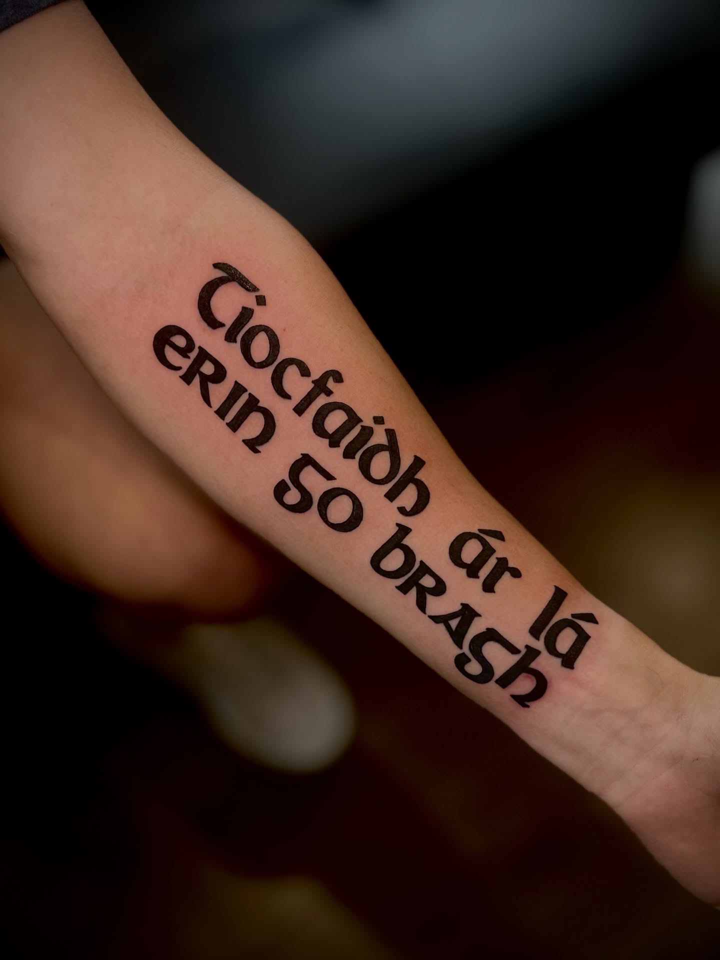 Tiocfaidh ár lá brath lettering script tattoo on the forearm by @tatt2st