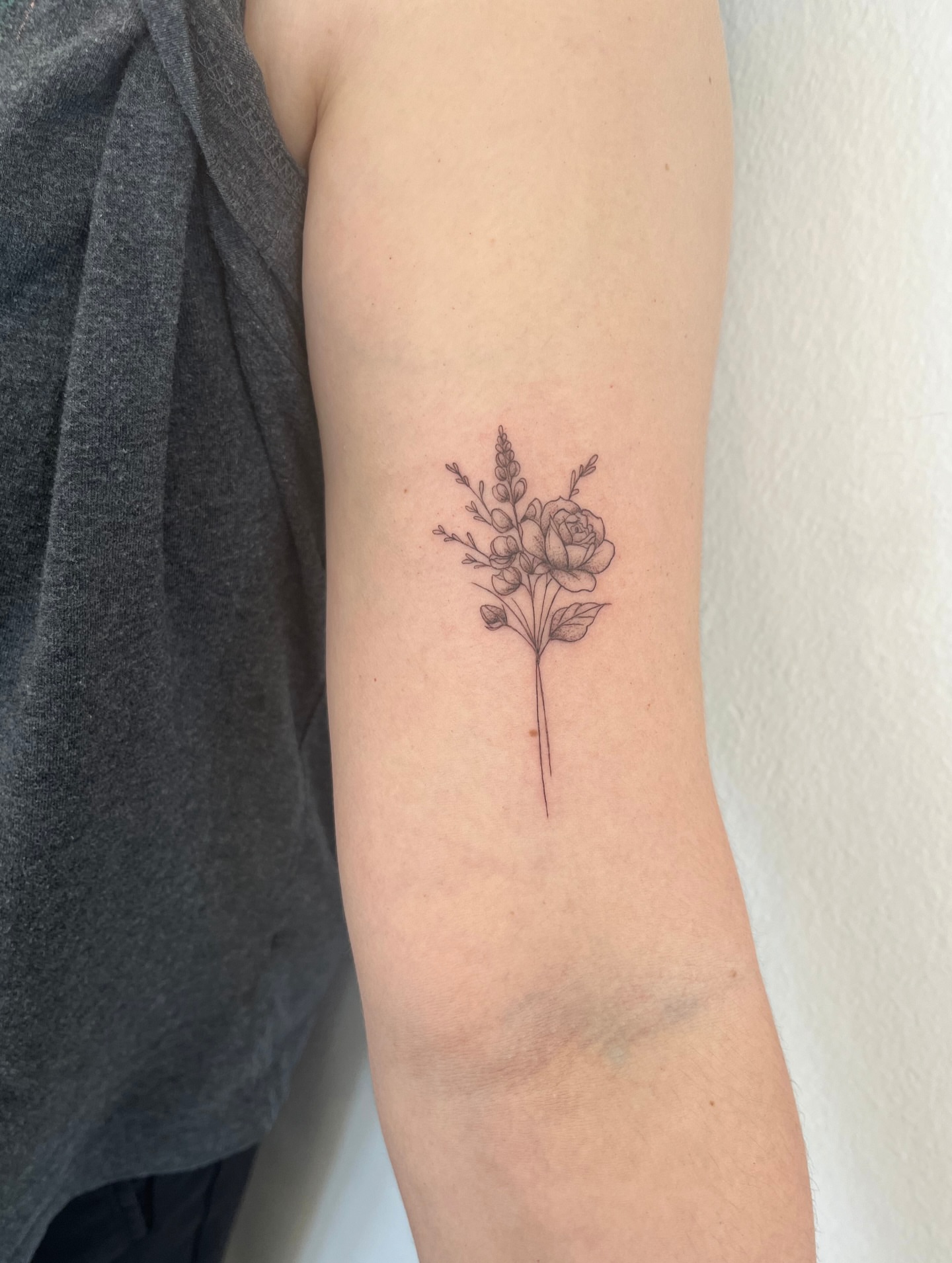 Flower arrangement fine line tattoo on the forearm by kt