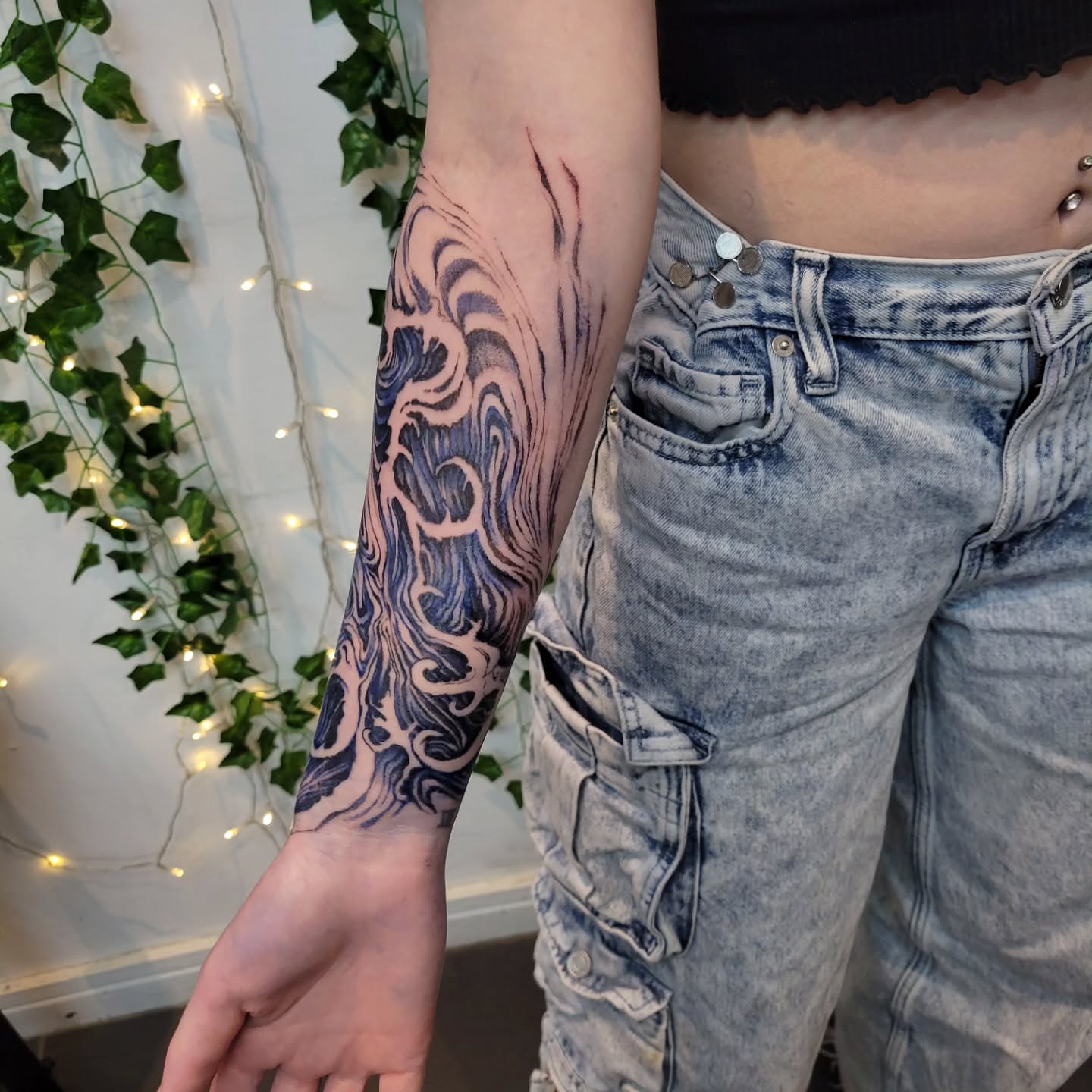 Wave black and grey tattoo on the forearm by Uku Tattoos, Cambridge, England