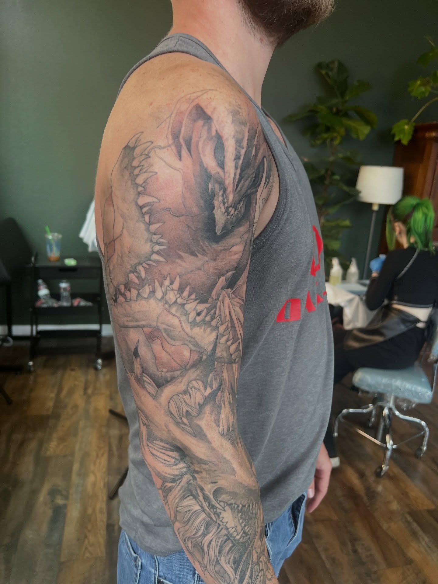 Demon dark realism tattoo on the upper arm by Jeremy Wiscombe