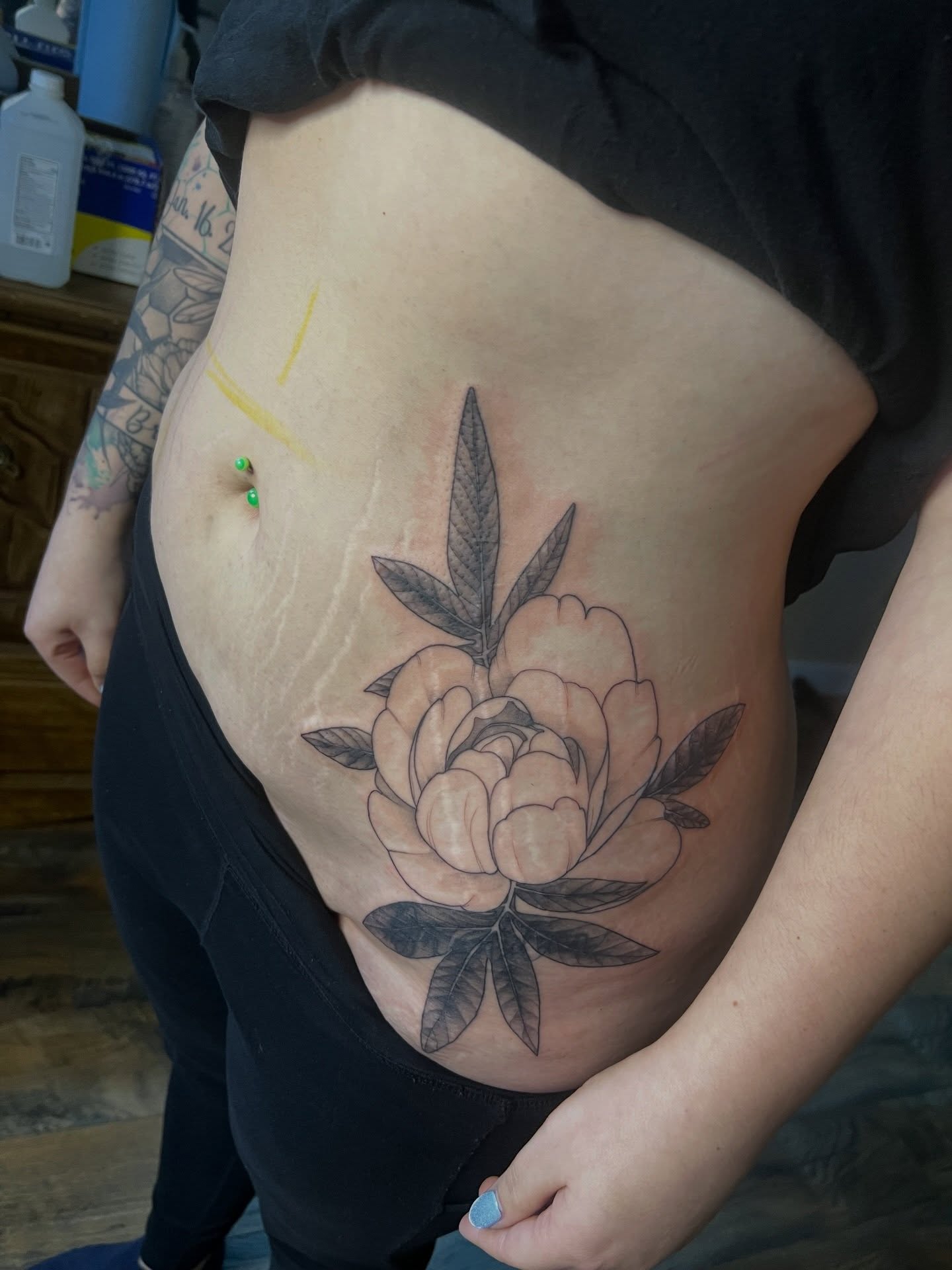 Peony black and grey tattoo on the torso by Jeremy Wiscombe