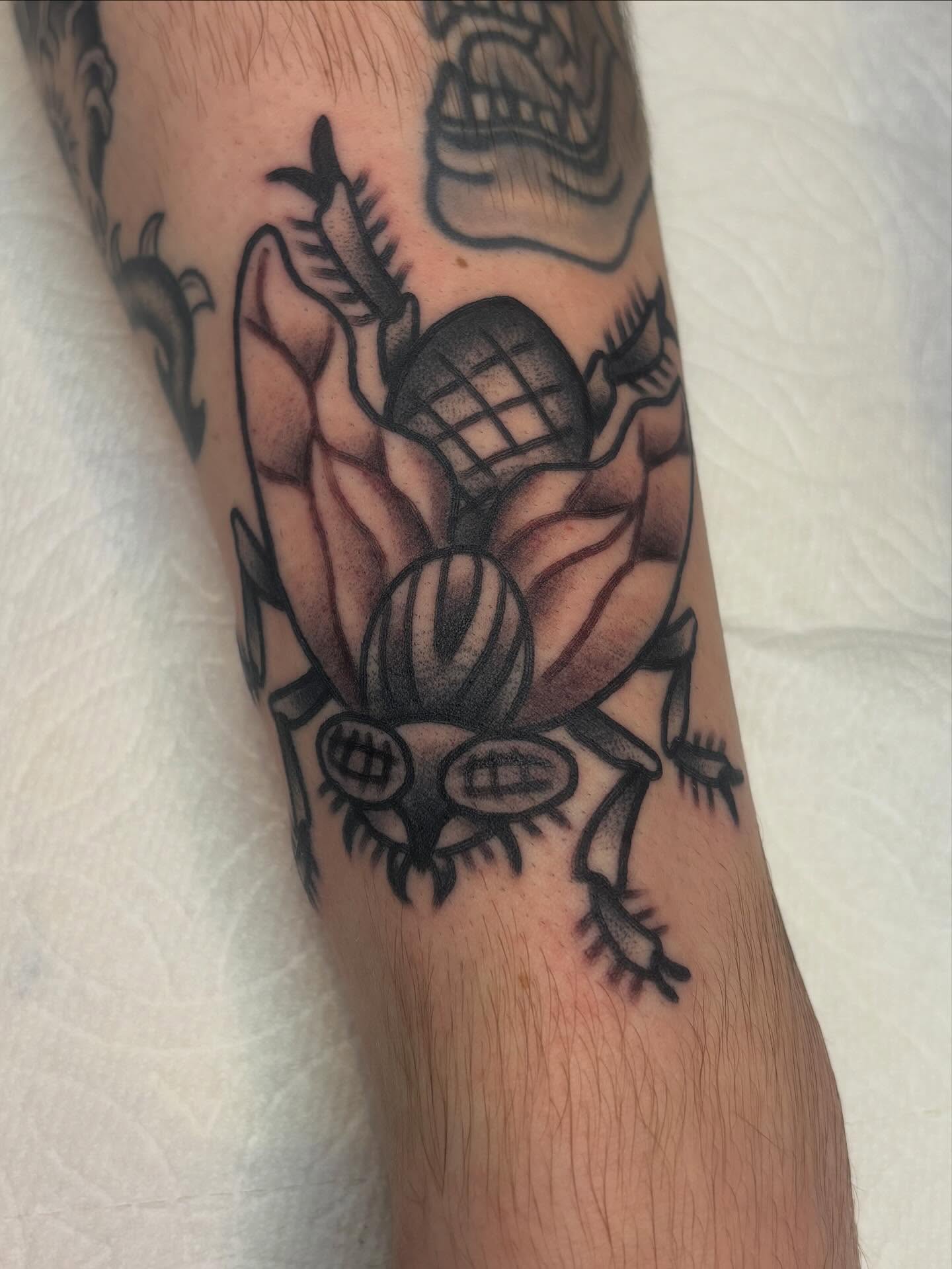 Beetle American traditional tattoo on the forearm by ๐๐๐ฏ๐ข๐ซ