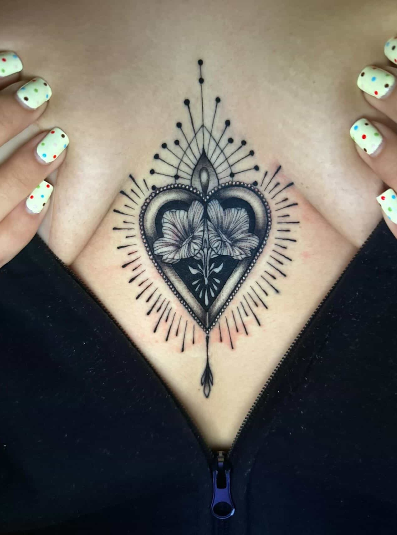 Heart with flowers dotwork tattoo on the chest by Sierra