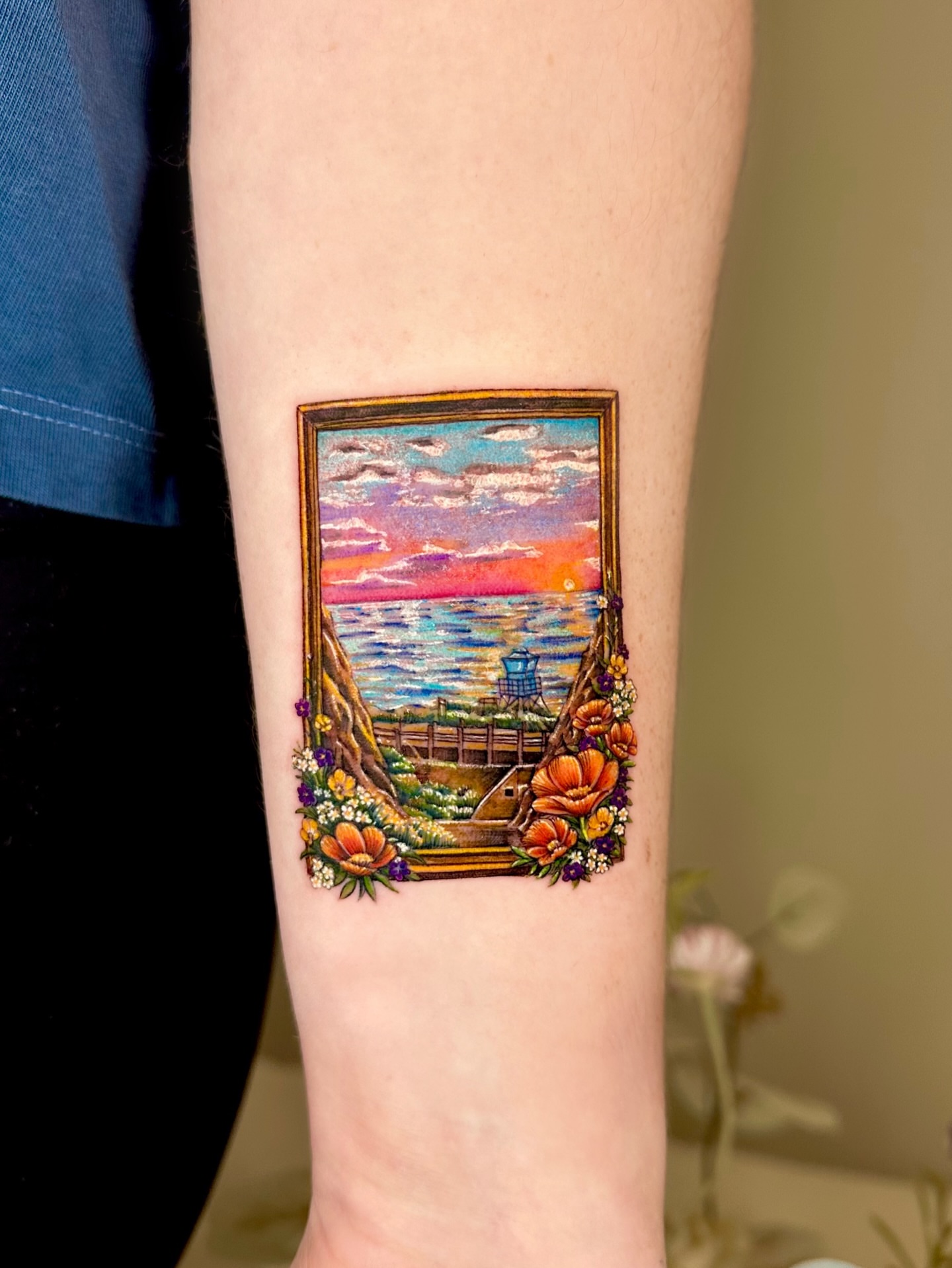 Beach sunset realism tattoo on the forearm by Claire